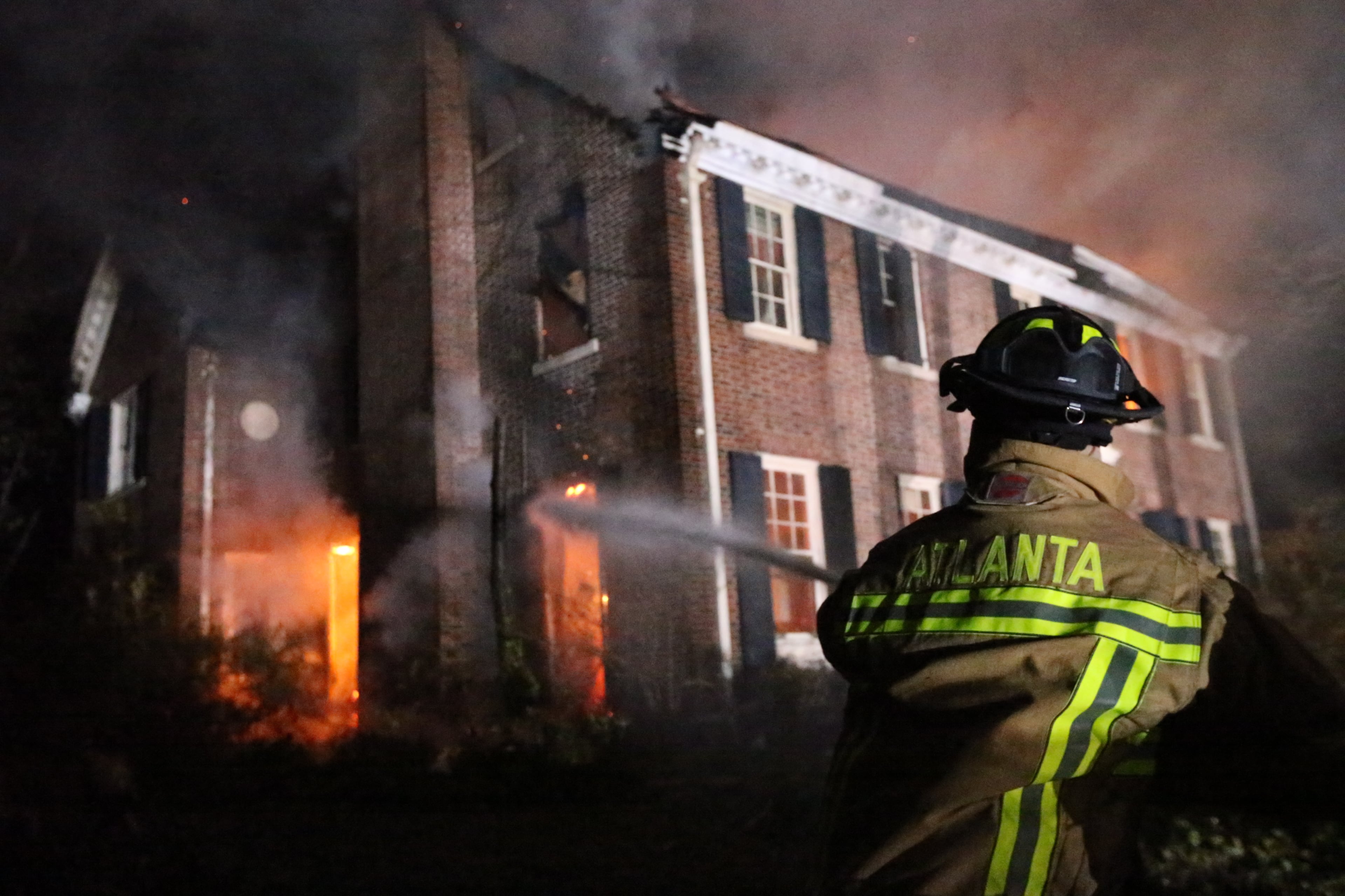 Two firefighters suffered minor injuries battling a Tuesday night blaze that destroyed a large, vacant home in the Druid Hills neighborhood of northeast Atlanta.