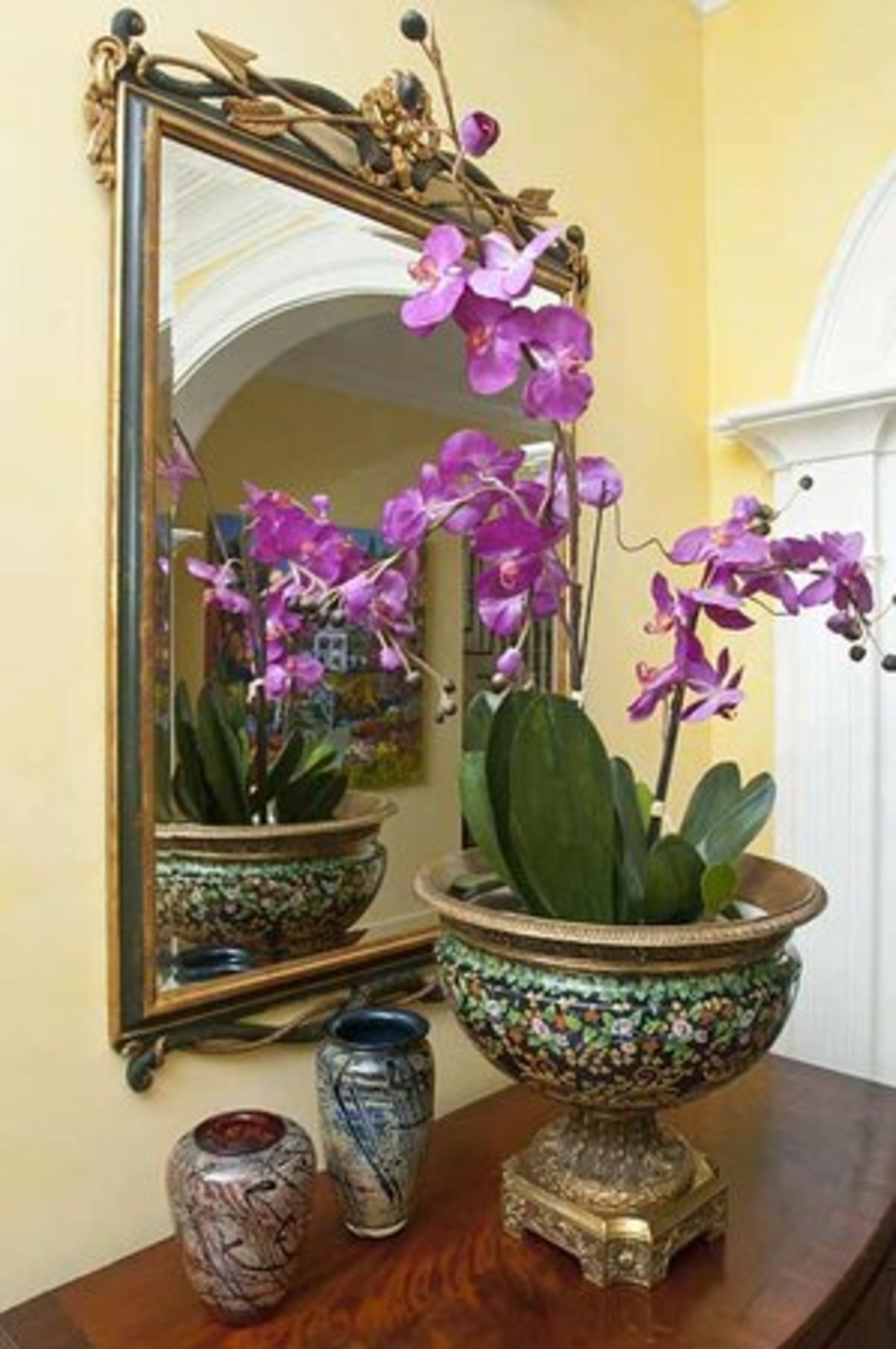 Venetian plaster created the smooth walls in the entry, using a yellow hue that reminds Barbara Dooley of sunshine. Flowers received as gifts are often on display in the home.