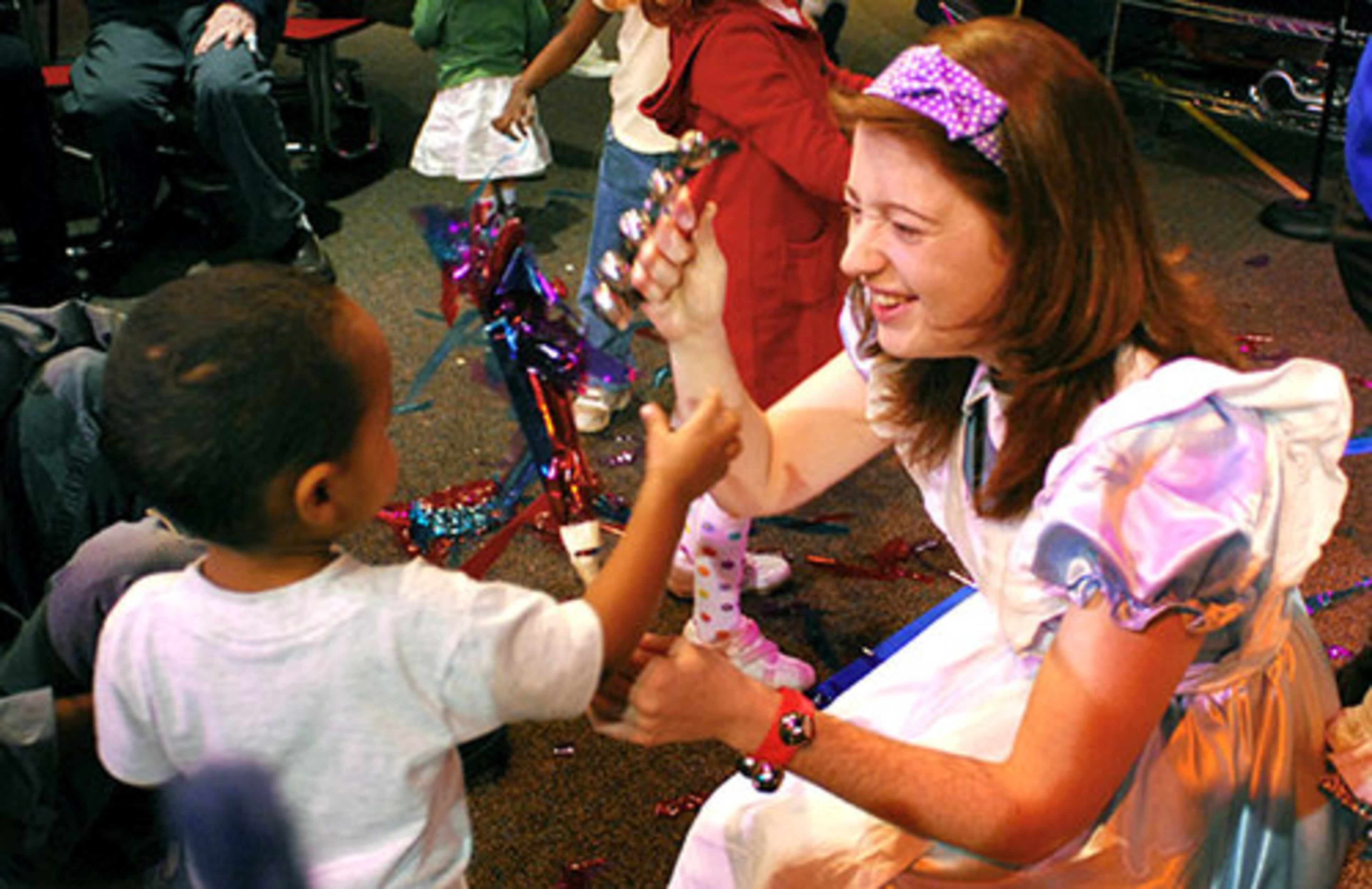 Museum Imaginator Amy Morrow gets into the excitement of dancing and "fireworks" waving with the children in attendance.