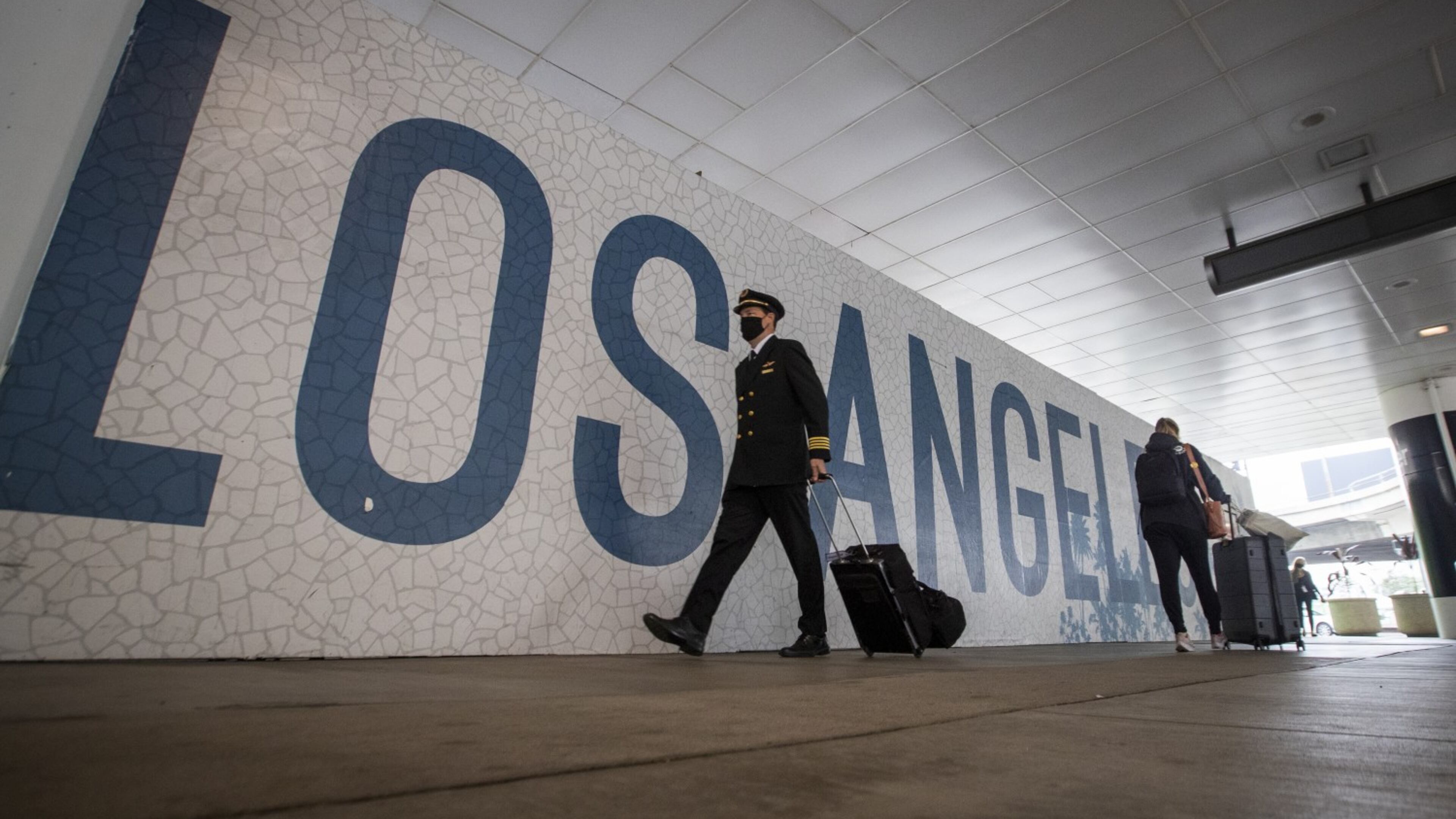 Travelers at Los Angeles International Airport. On Friday, a passenger opened the door of a plane as it was taxiing away from the gate area and jumped out.