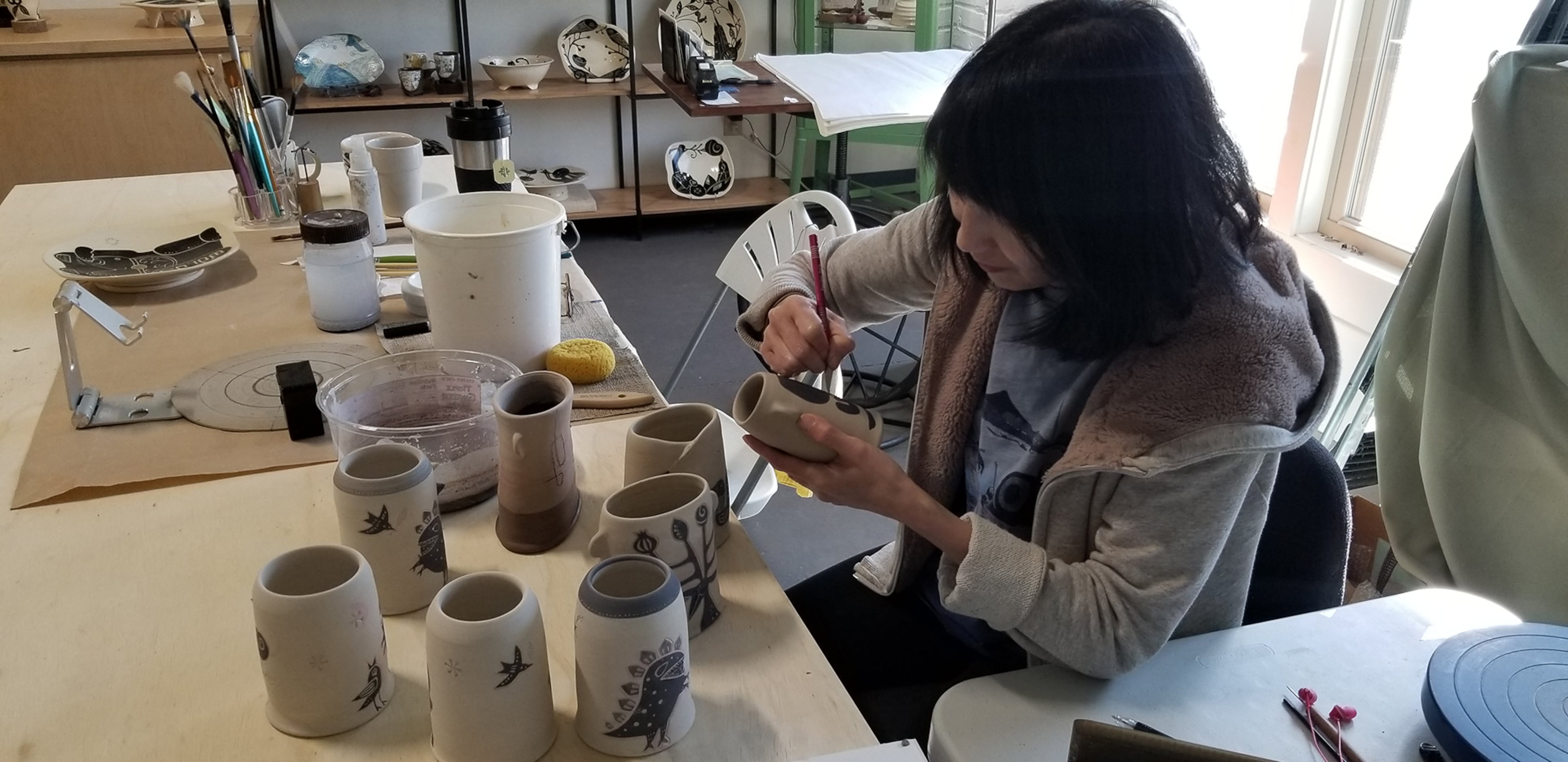 Reiko Miyagi paints hand-thrown decorative ceramics at Tabula Rasa, her studio in the River Arts District in Asheville, North Carolina.
Courtesy of Tracey Teo