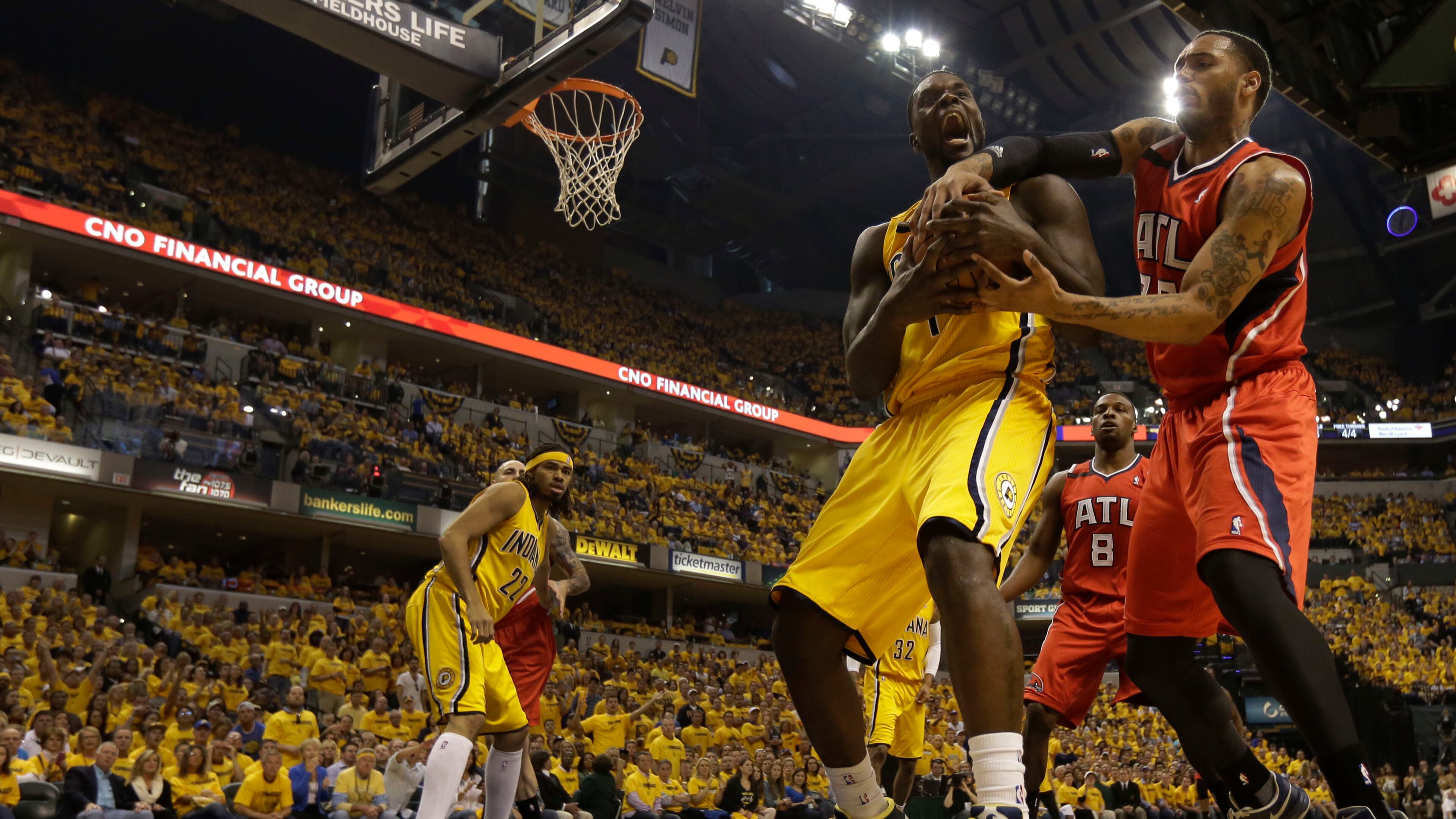 Indiana Pacers guard Lance Stephenson, front left, fights for control of a rebound with Atlanta Hawks forward Mike Scott in the first half during Game 7 of a first-round NBA basketball playoff series in Indianapolis, Saturday, May 3, 2014.