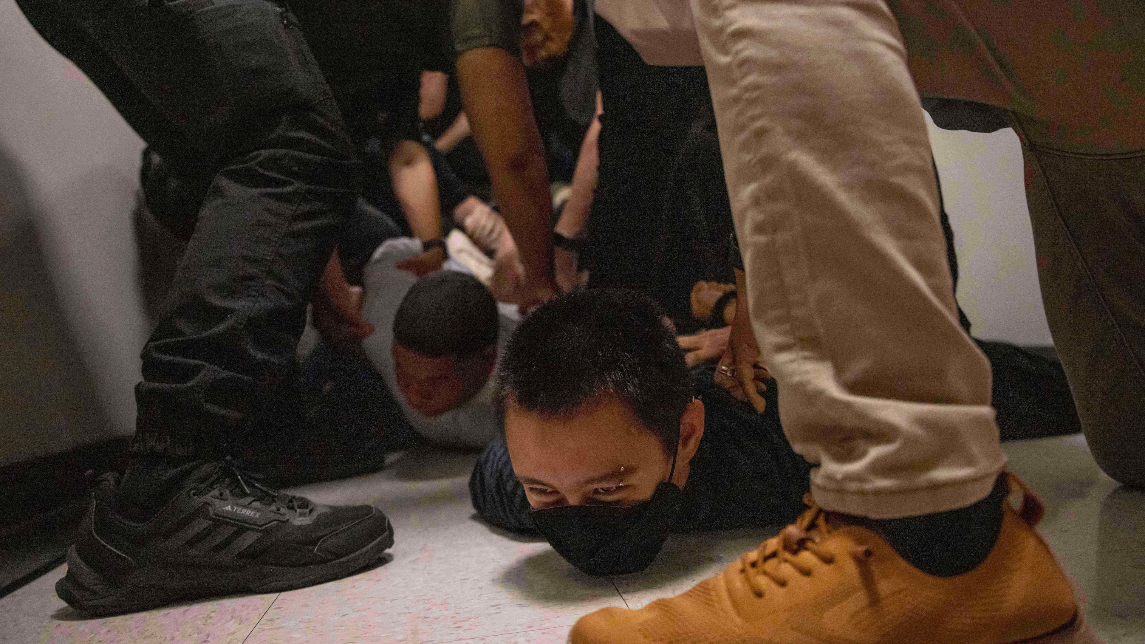 FILE - A Dominican man, left, and an activist, right, are detained by plainclothes officers with Immigration and Customs Enforcement after an immigration hearing at the immigration court inside the Jacob K. Javits Federal Building in New York, on June 6, 2025. (AP Photo/Yuki Iwamura, File)