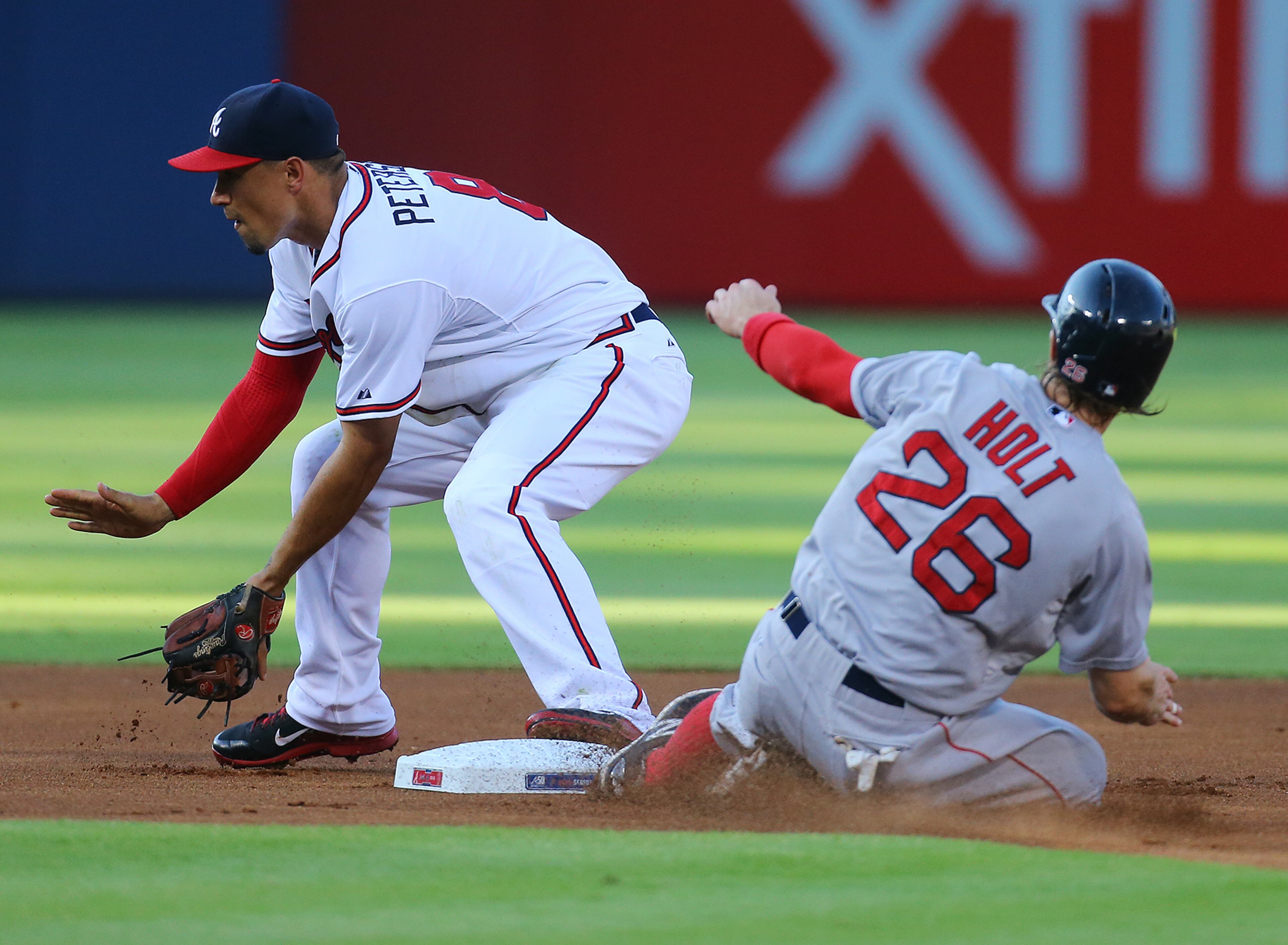 Red Sox Brock Holt is out at second by Braves Jace Peterson on a grounder by Xander Bogaerts on a close play that held up after a review during the first inning in a baseball game on Wednesday, June 17, 2015, in Atlanta. Curtis Compton / ccompton@ajc.com