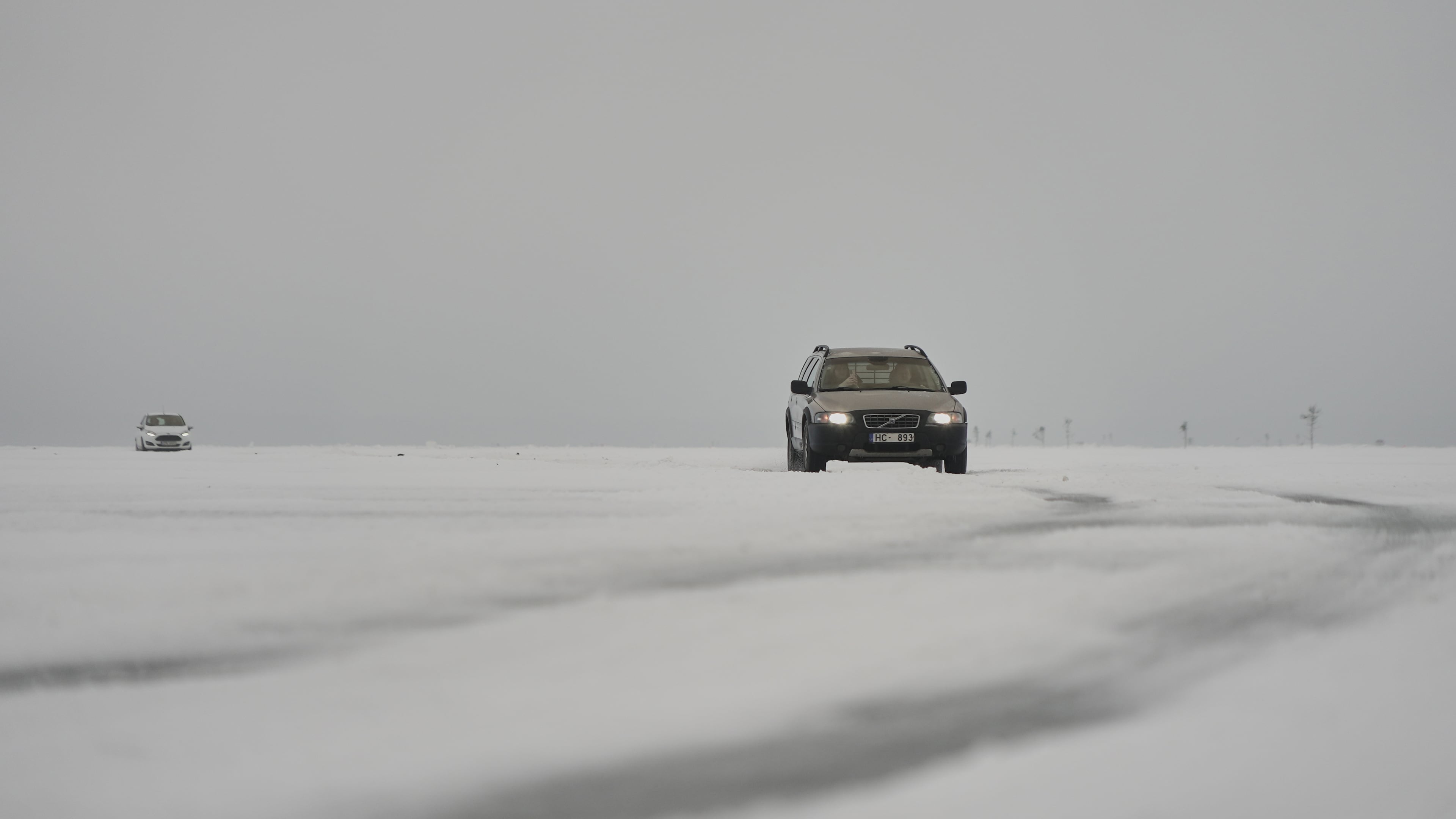 Two cars cross the frozen Soela Strait in the Baltic Sea near Hiiumaa, Estonia, Tuesday, Feb. 10, 2026. (AP Photo/Kostya Manekov)
