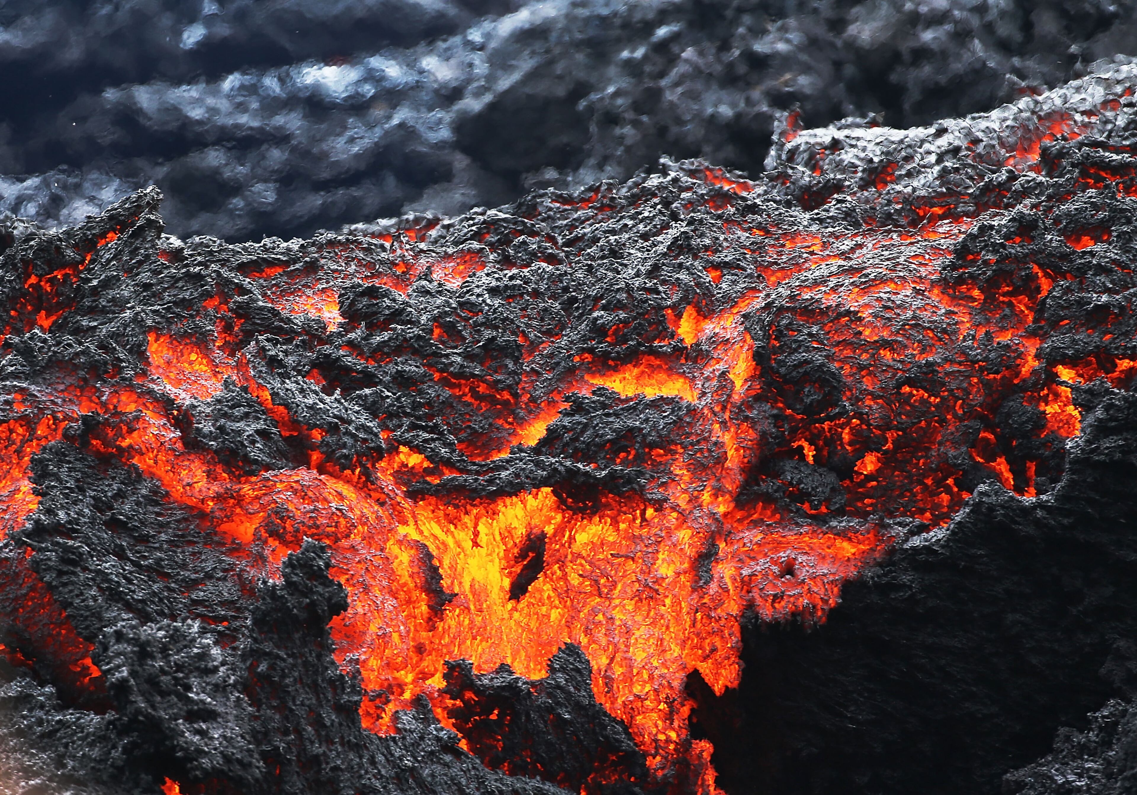 PAHOA, HI - MAY 12: Lava flows at a lava fissure in the aftermath of eruptions from the Kilauea volcano on Hawaii's Big Island, on May 12, 2018 in Pahoa, Hawaii. The U.S. Geological Survey said a recent lowering of the lava lake at the volcano's Halemaumau crater Ãhas raised the potential for explosive eruptionsà at the volcano. Authorities have confirmed the fissure is the 16th to open. (Photo by Mario Tama/Getty Images)