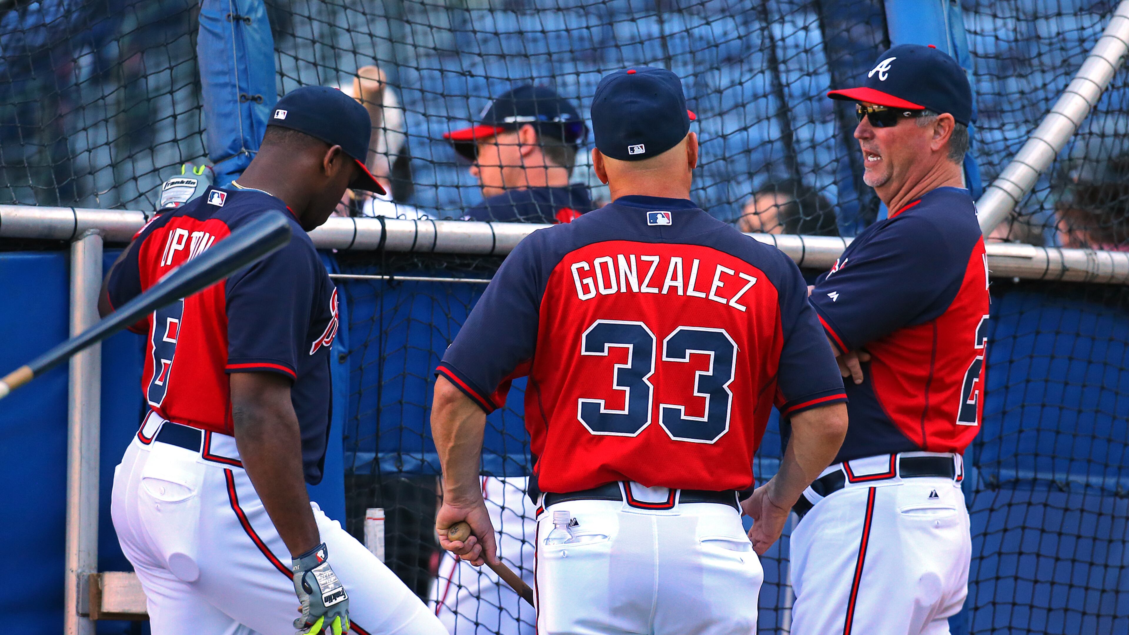 Braves manager Fredi Gonzalez (center) talks with hitting coach Greg Walker (right) and Justin Upton (left) during team batting practice before playing the Pirates on Wednesday, Sept. 24, 2014, in Atlanta.