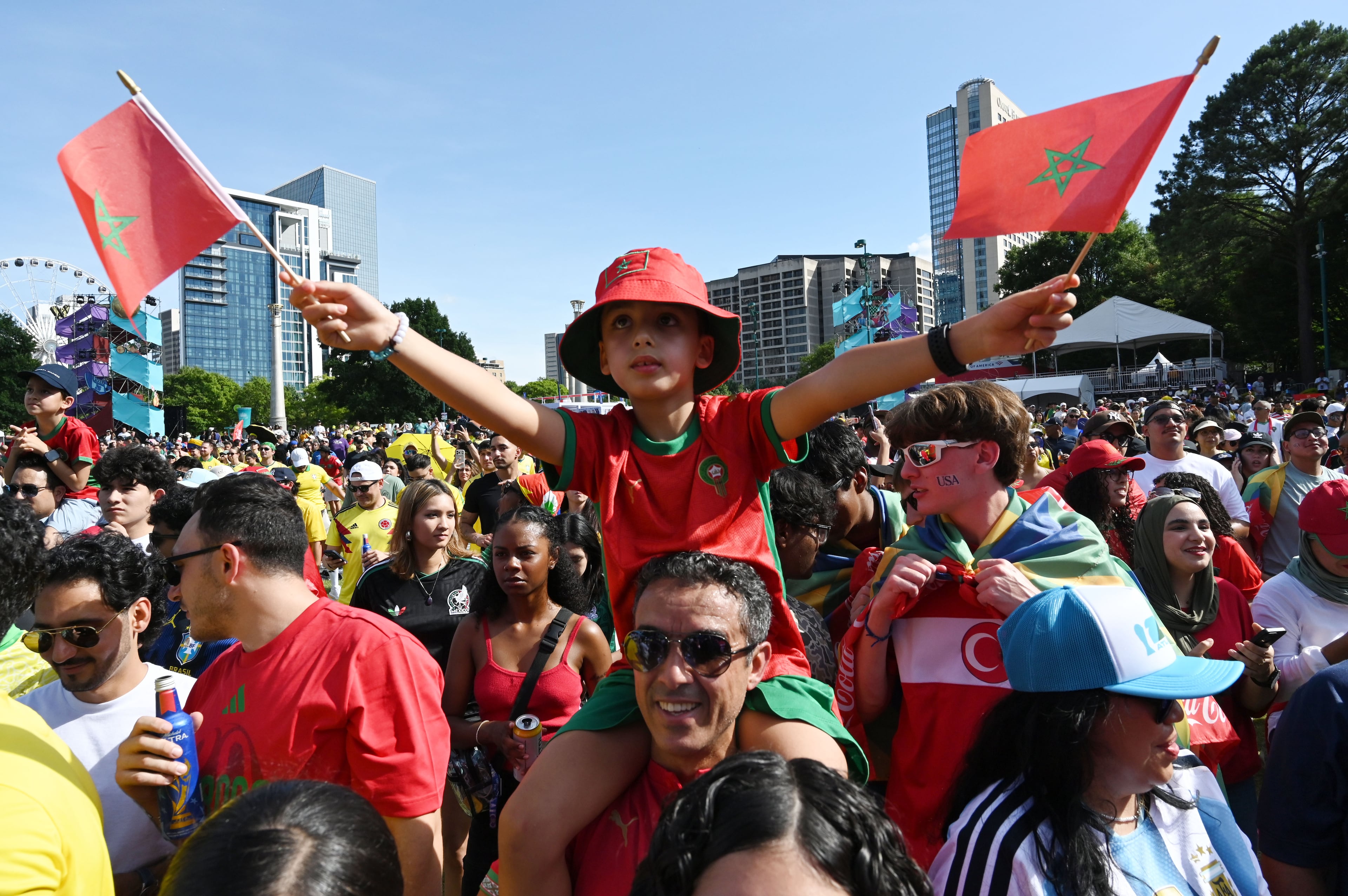 Local Moroccan fans cheer as they gather for a watch party ahead of the match against Brazil at the FIFA Fan Festival in Centennial Olympic Park. (Hyosub Shin/AJC)