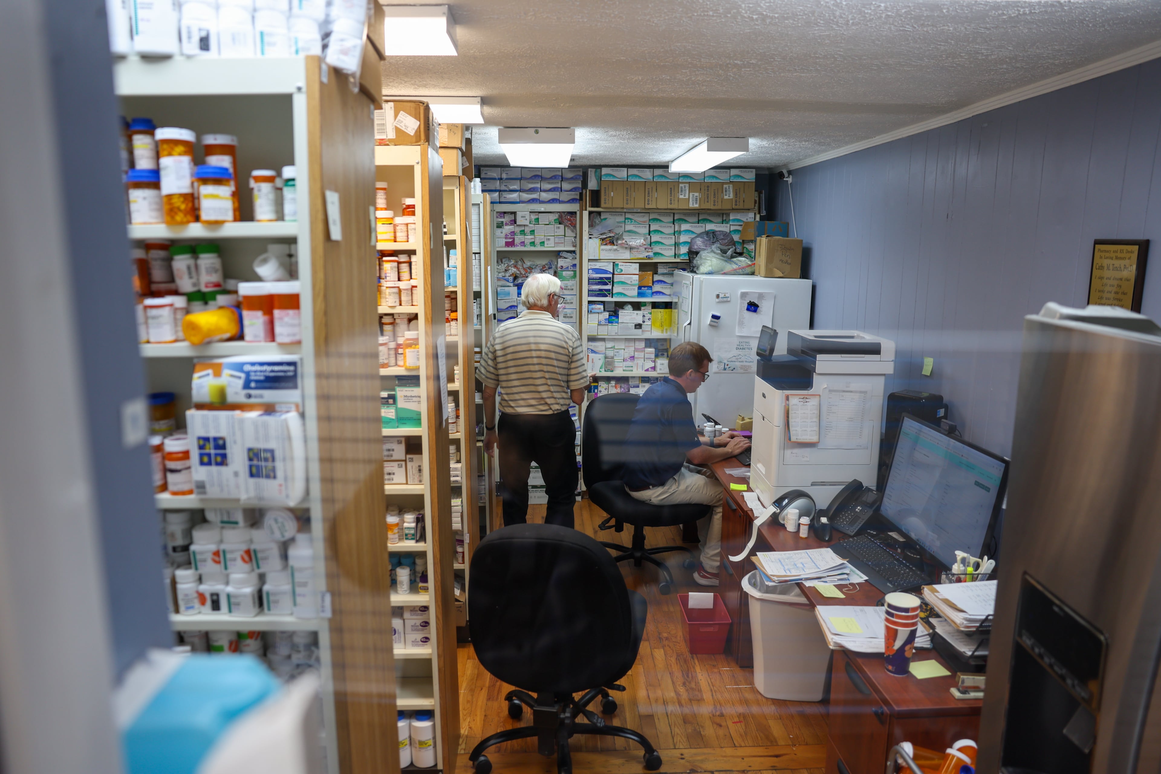 Volunteer pharmacists work at Open Arms Clinic, a free clinic in Toccoa, on Sept. 29, 2026. The clinic provides free care to low-income residents who make less than $20,000 a year. Since COVID-era enhanced Obamacare subsidies expired late last year, the clinic's patient load has doubled. (Arvin Temkar/AJC)