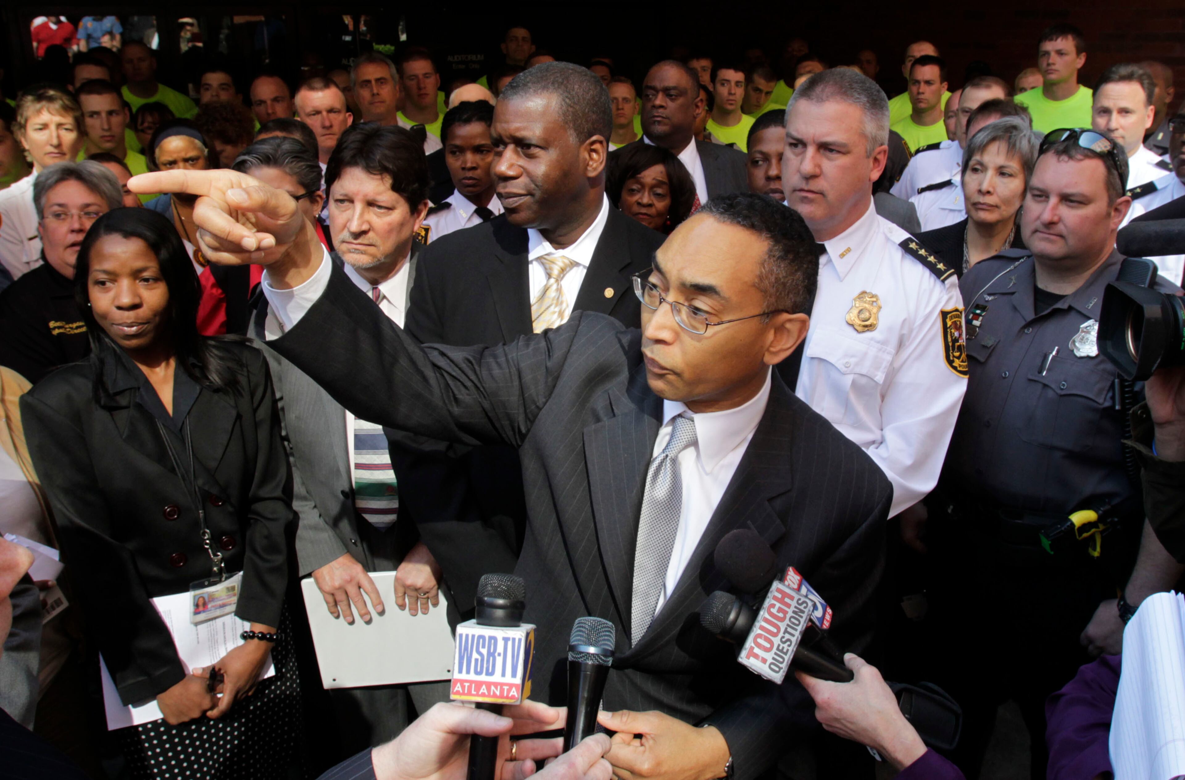 CEO Burrell Ellis (center), surrounded by public service personnel and recruits, holds a press conference outside the auditorium on February 22, 2011. He has proposed a property tax increase, but commissioners are expected to vote against raising taxes. Hundreds of police officers, firefighters and other DeKalb County employees rallied before the County Commission Tuesday morning to protest proposed budget cuts. The officers filled the Maloof Auditorium in Decatur for the County Commission meeting. The Commission is scheduled to approve a $530 million budget with $33.6 million in cuts. The cuts equal about 800 layoffs. Bob Andres/bandres@ajc.com