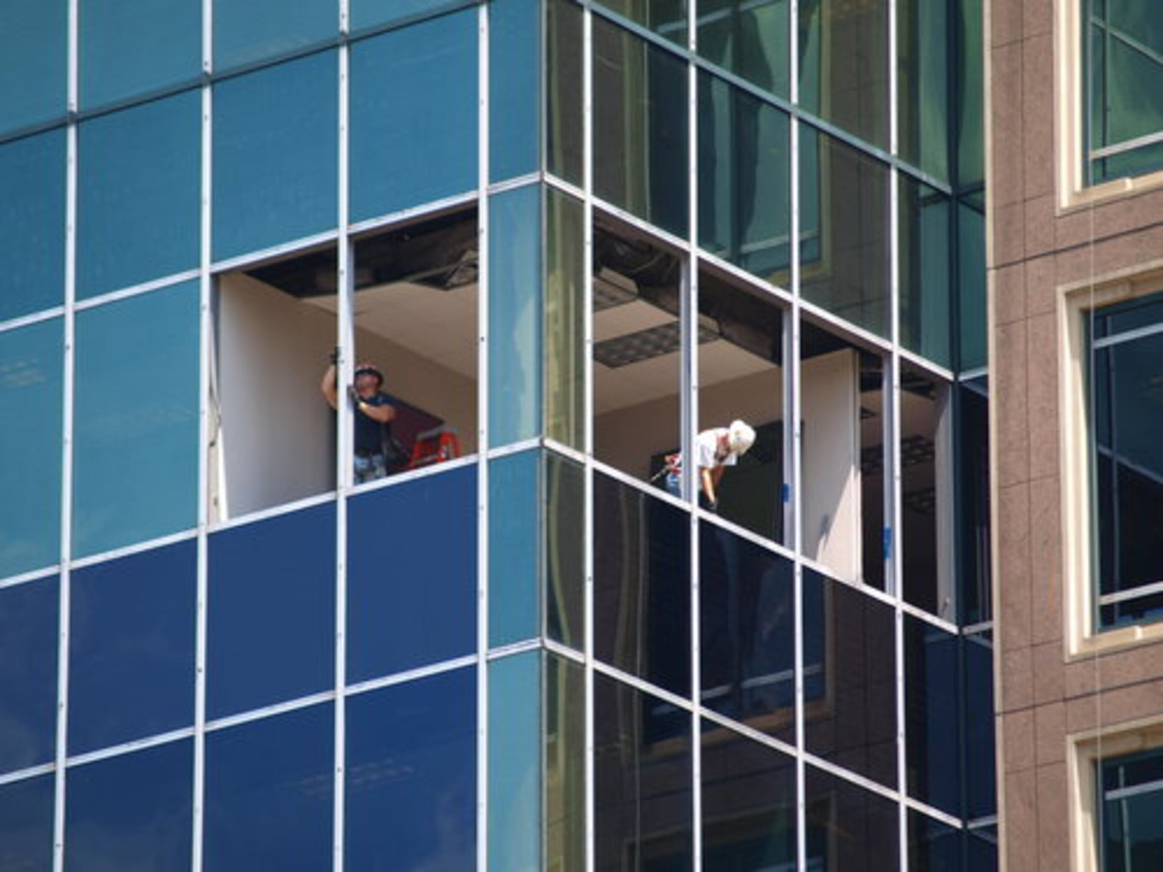 Workers are replacing windows in the Campanile. The bank will take five of the lower floors of the 21-story Campanile, bringing the building to 50 percent leased.