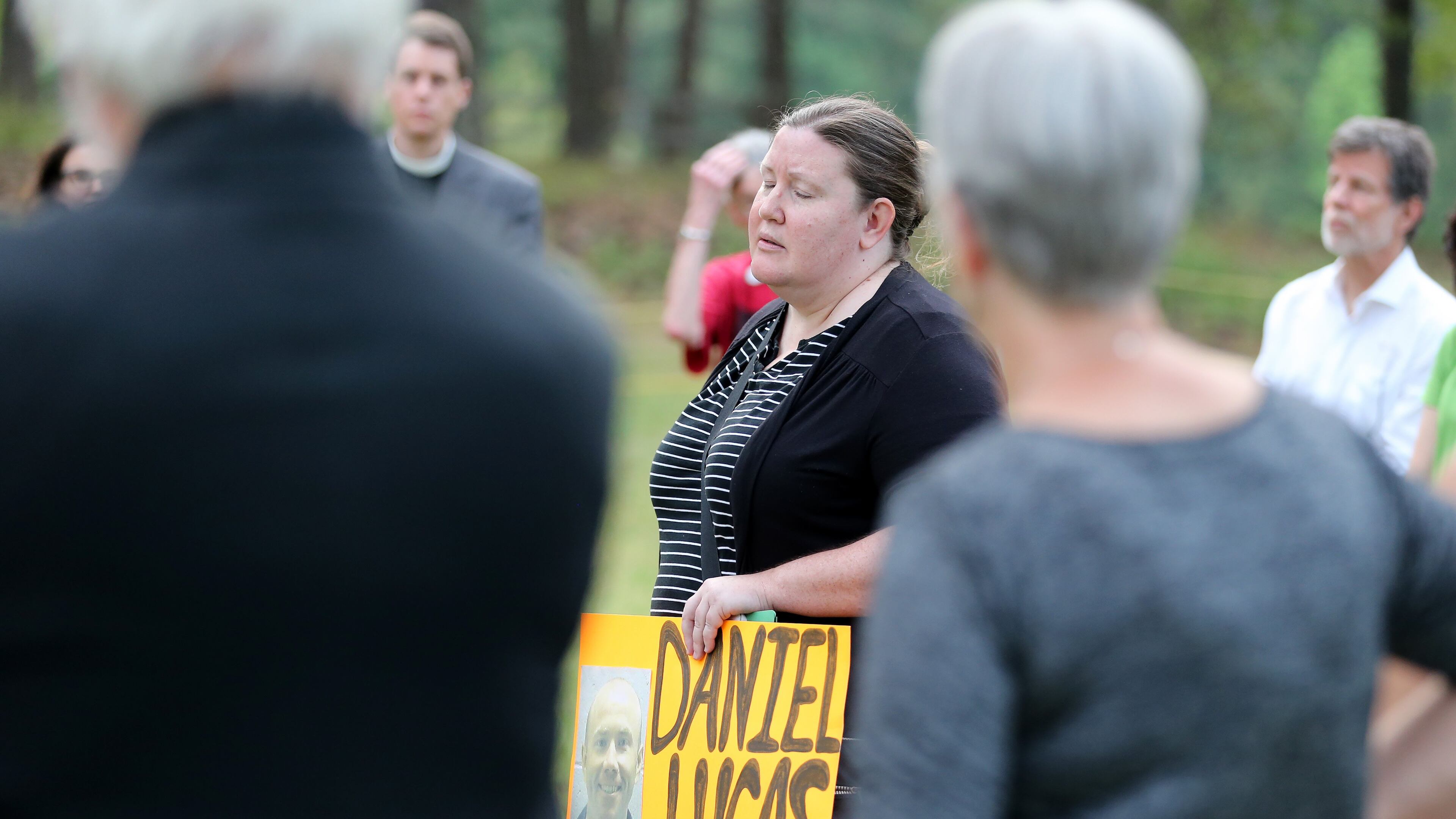 Mary Catherine Johnson, with Georgians for Alternatives to the Death Penalty, holds a photo of Daniel Anthony Lucas while leading a vigil outside of the Georgia Diagnostic and Classification State Prison in Jackson on Wednesday evening April 27, 2016 at the time Lucas was scheduled to be executed for the 1998 murders of a Jones County father and his two children. Ben Gray / bgray@ajc.com