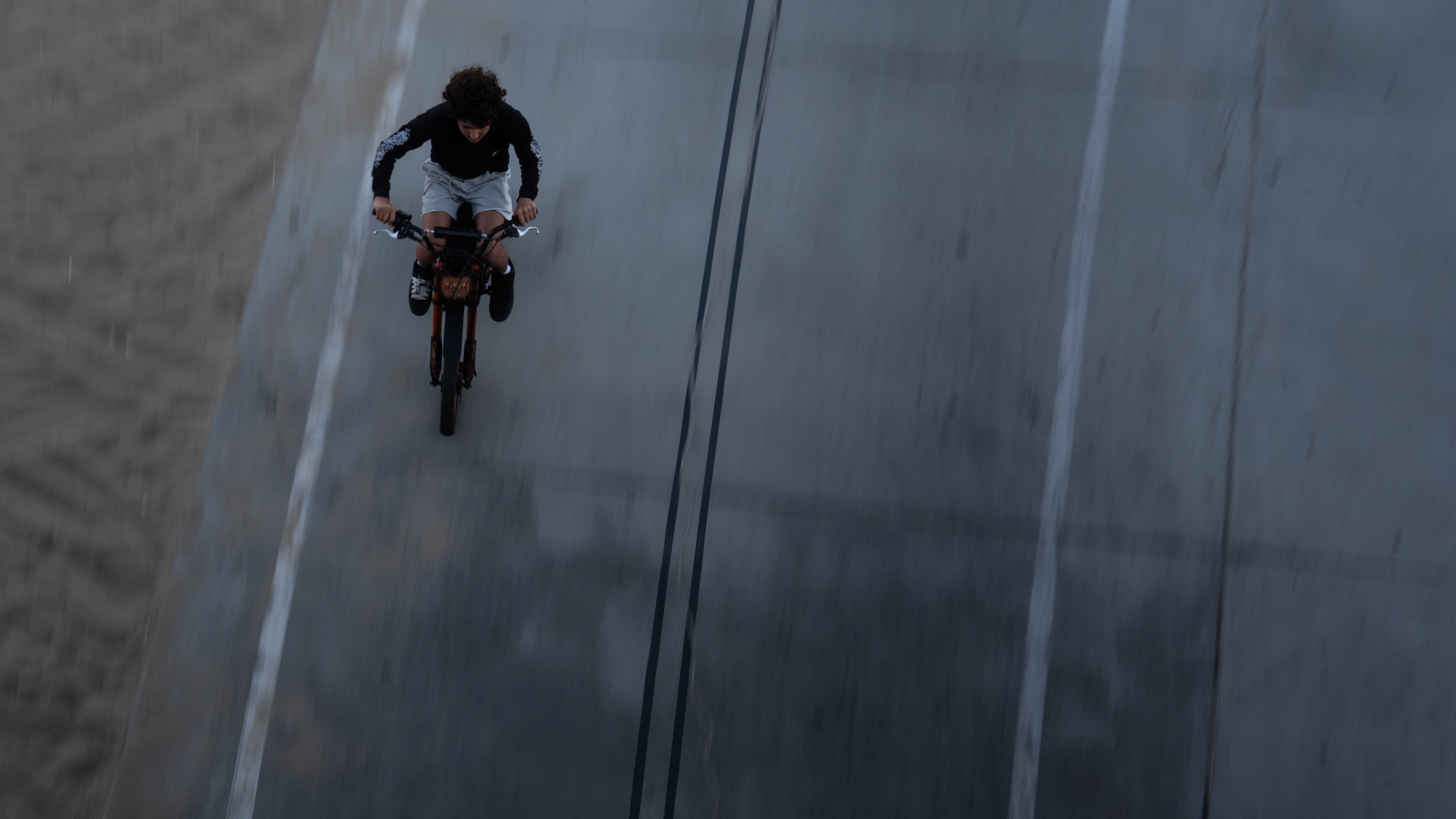 A boy rides an e-bike in Santa Monica, Calif., Monday, Aug. 10, 2026. (AP Photo/Jae C. Hong)