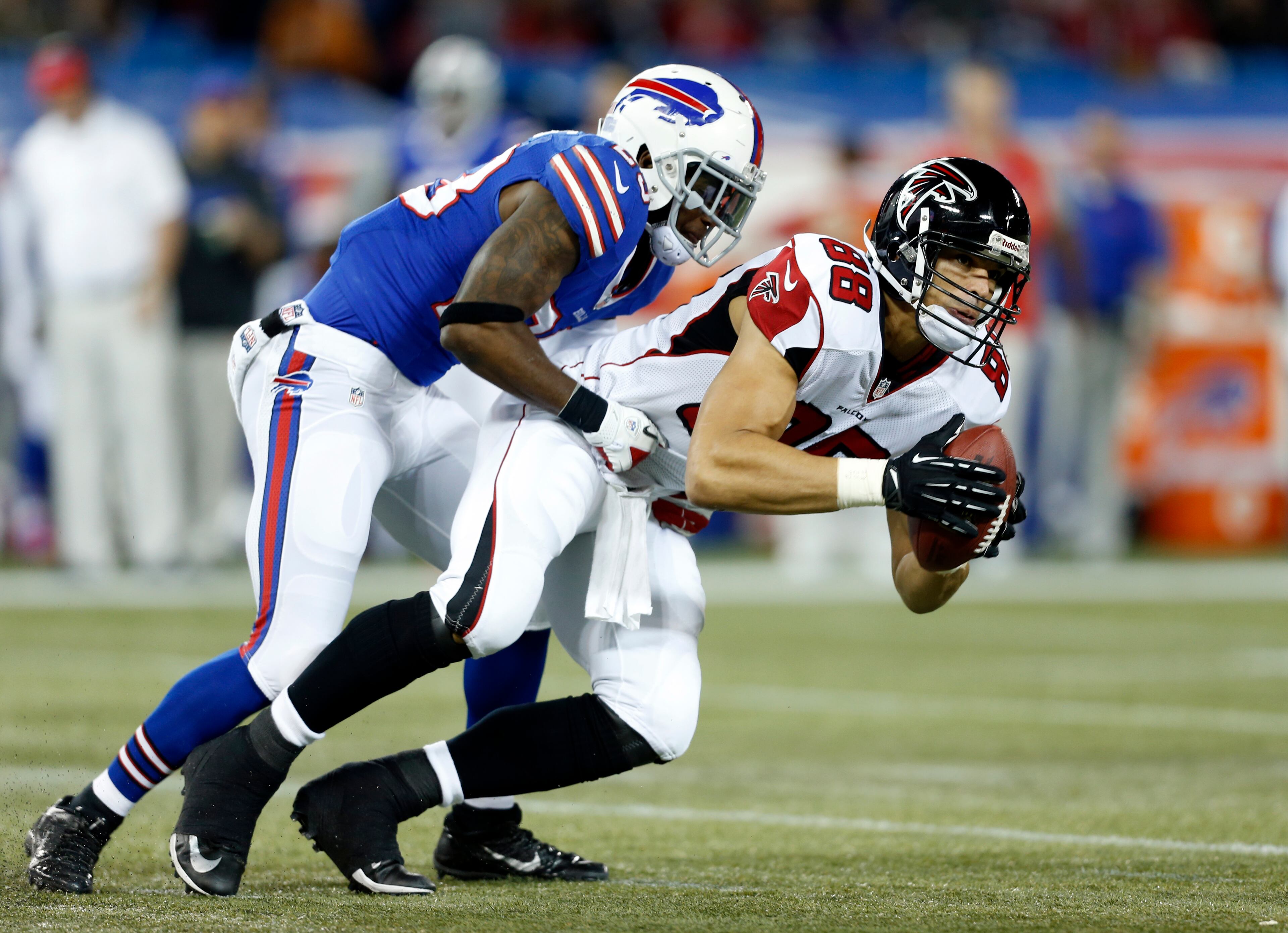 Atlanta Falcons tight end Tony Gonzalez (88) is tackled by Buffalo Bills free safety Aaron Williams (23) during the first half of an NFL football game on Sunday, Dec. 1, 2013, in Toronto.