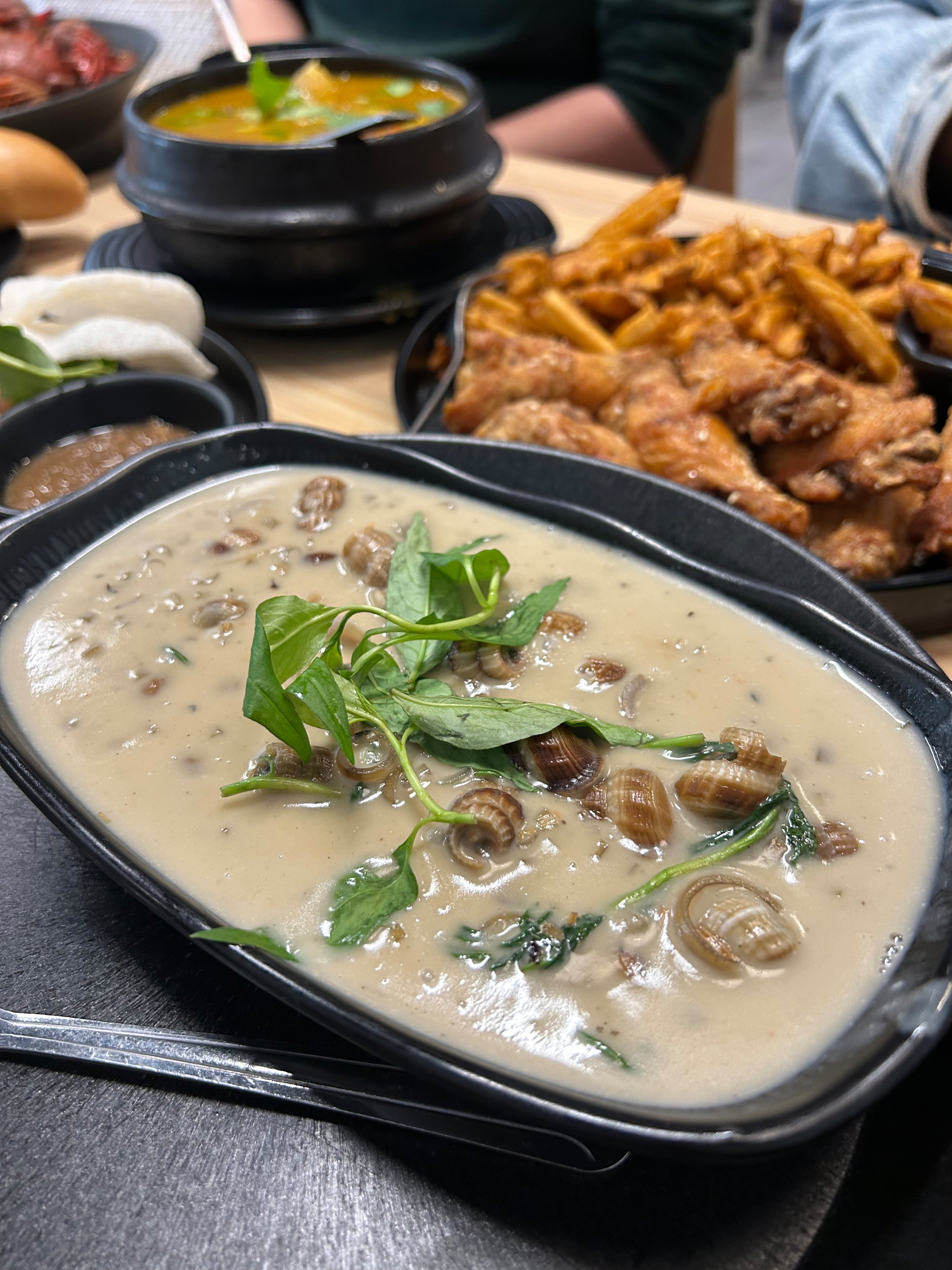 Periwinkle snails in lemongrass coconut sauce at Saigon District. (Candy Hom for the AJC)