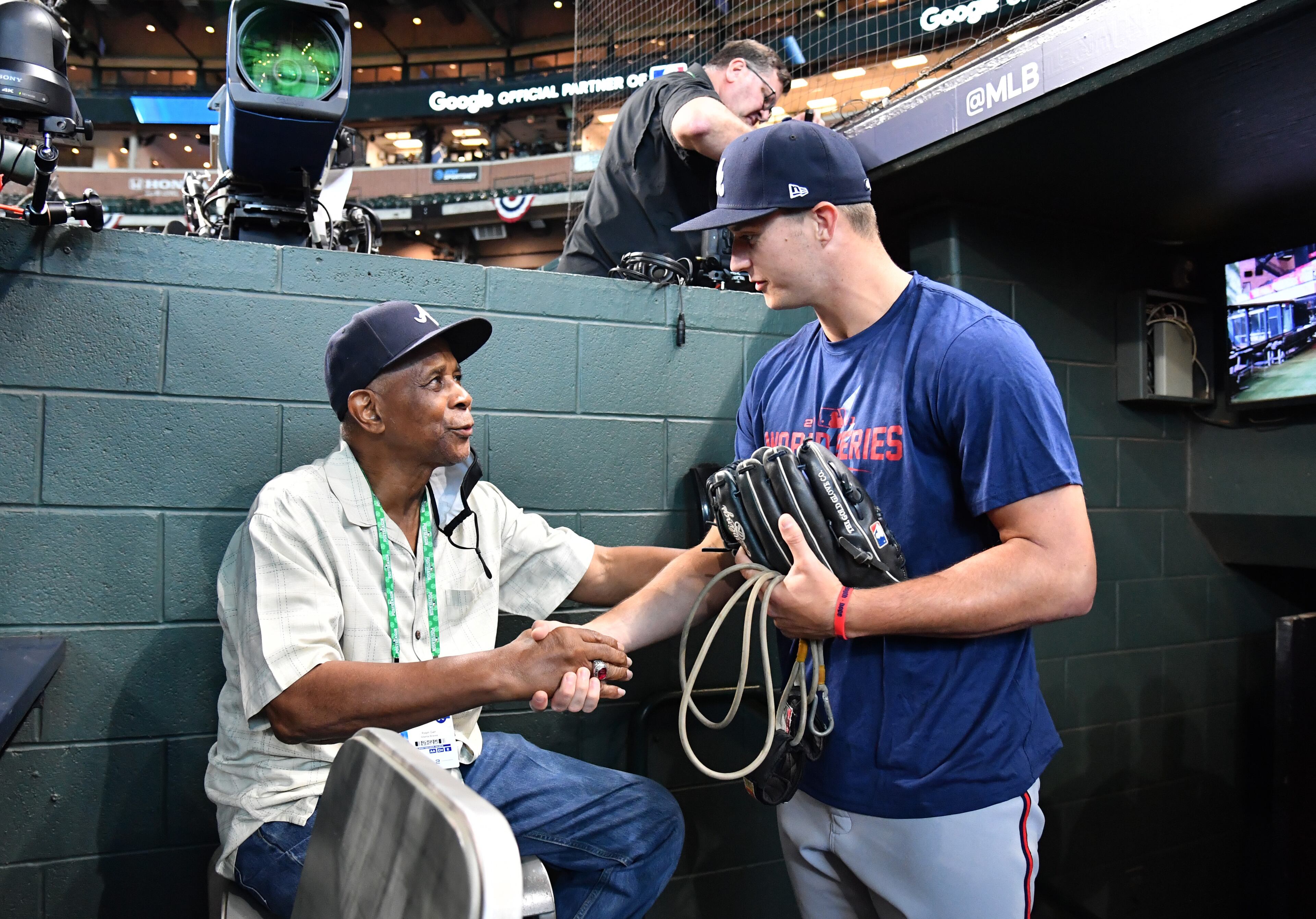 Pitcher Tucker Davidson, replacing Charlie Morton, is greeted by former Atlanta Braves player Ralph Garr as he takes on the field prior to Game 2 of baseball's World Series at Minute Maid Park in Houston on Wednesday, October 27, 2021. (Hyosub Shin / Hyosub.Shin@ajc.com)