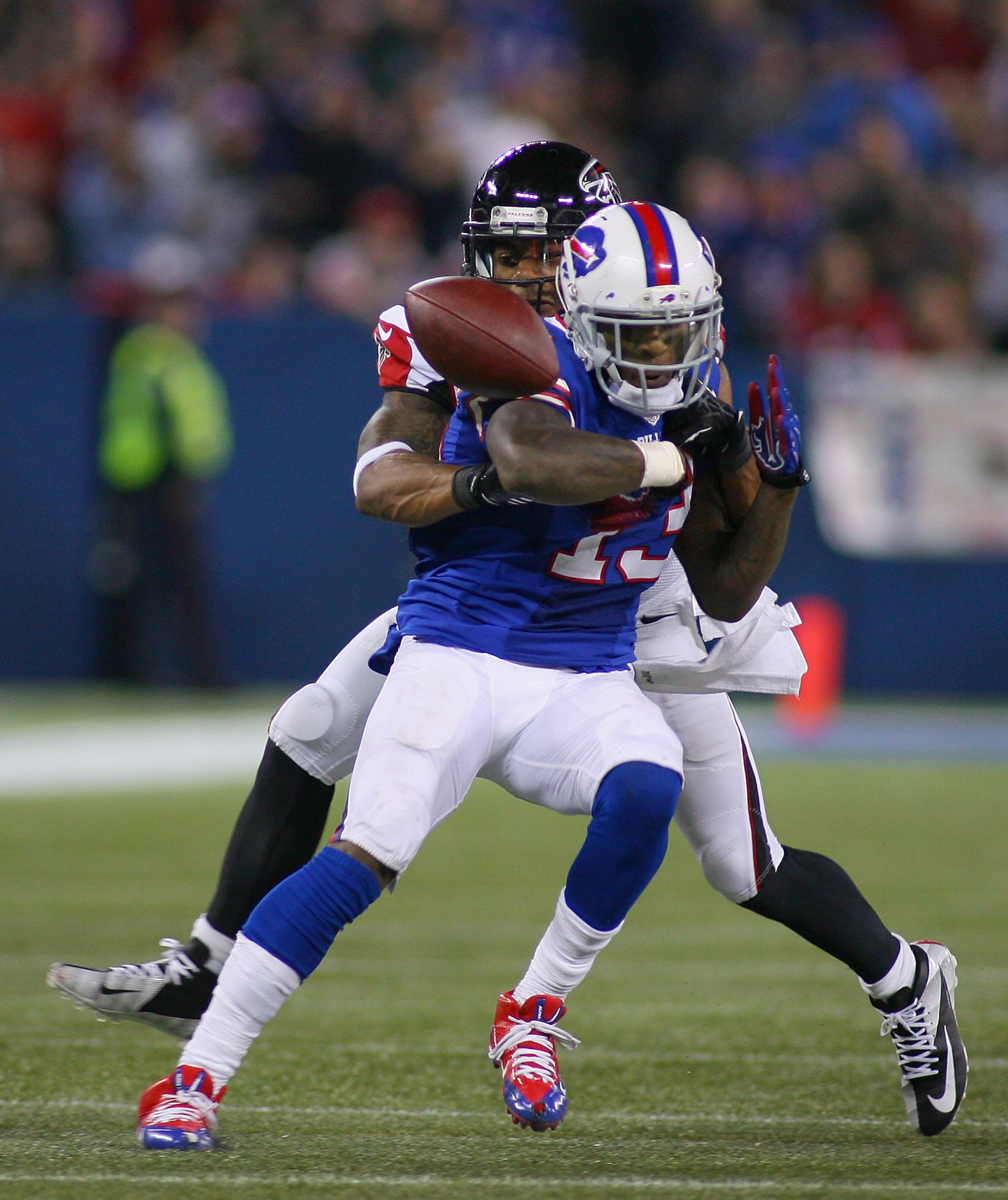 Steve Johnson #13 of the Buffalo Bills fumbles in the last minute of regulation as Robert McClain #27 of the Atlanta Falcons strips the ball at Rogers Centre in Toronto, Ontario. Atlanta won 34-31 in overtime.