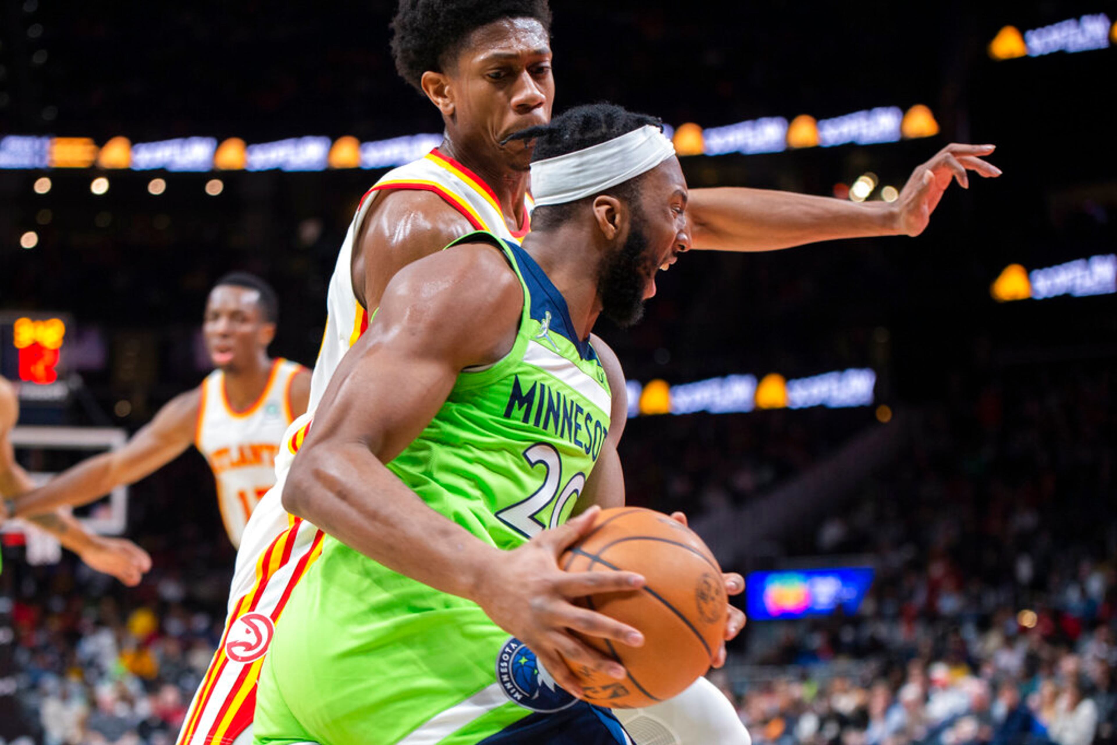 Minnesota Timberwolves forward Josh Okogie (20) drives past Atlanta Hawks forward De'Andre Hunter during the second half of an NBA basketball game Wednesday, Jan. 19, 2022, in Atlanta. (AP Photo/Hakim Wright Sr.)