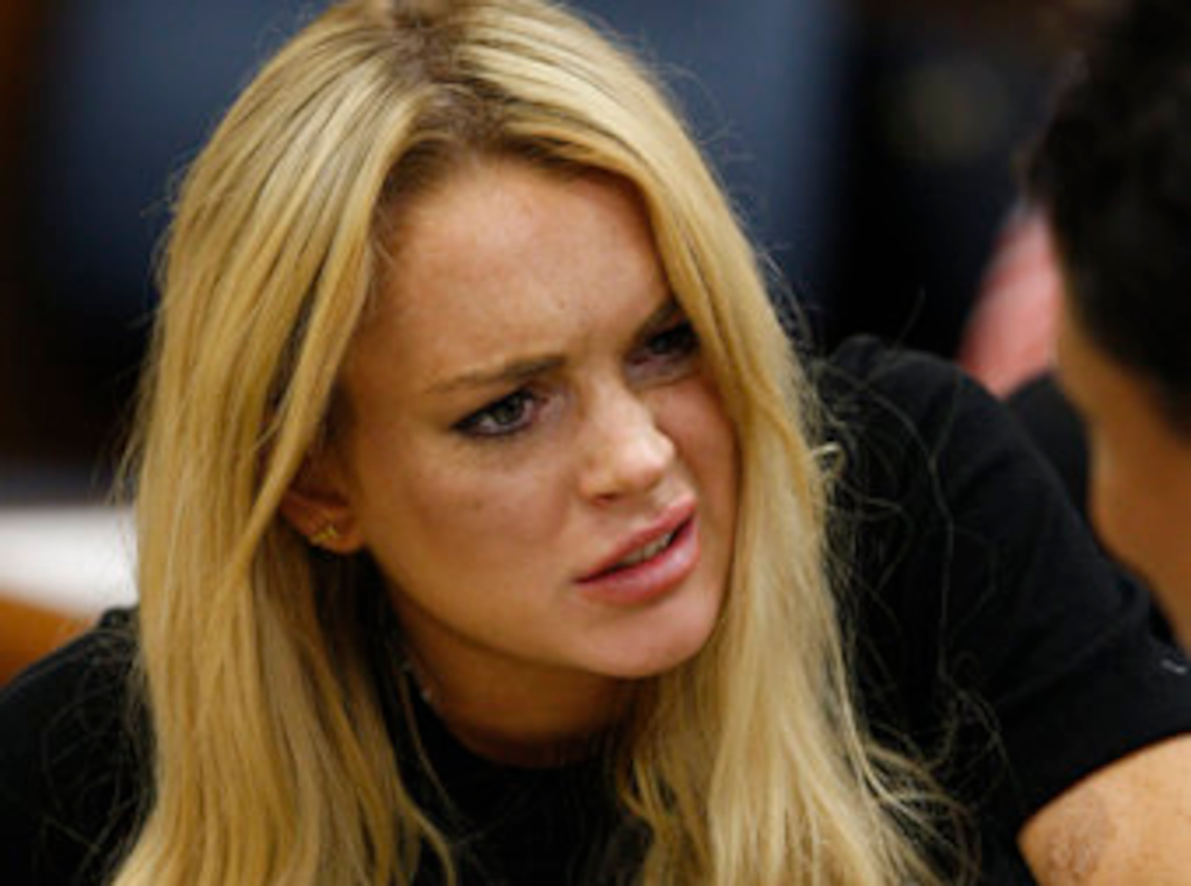 Lindsay Lohan talks to her attorney Shawn Chapman Holley.