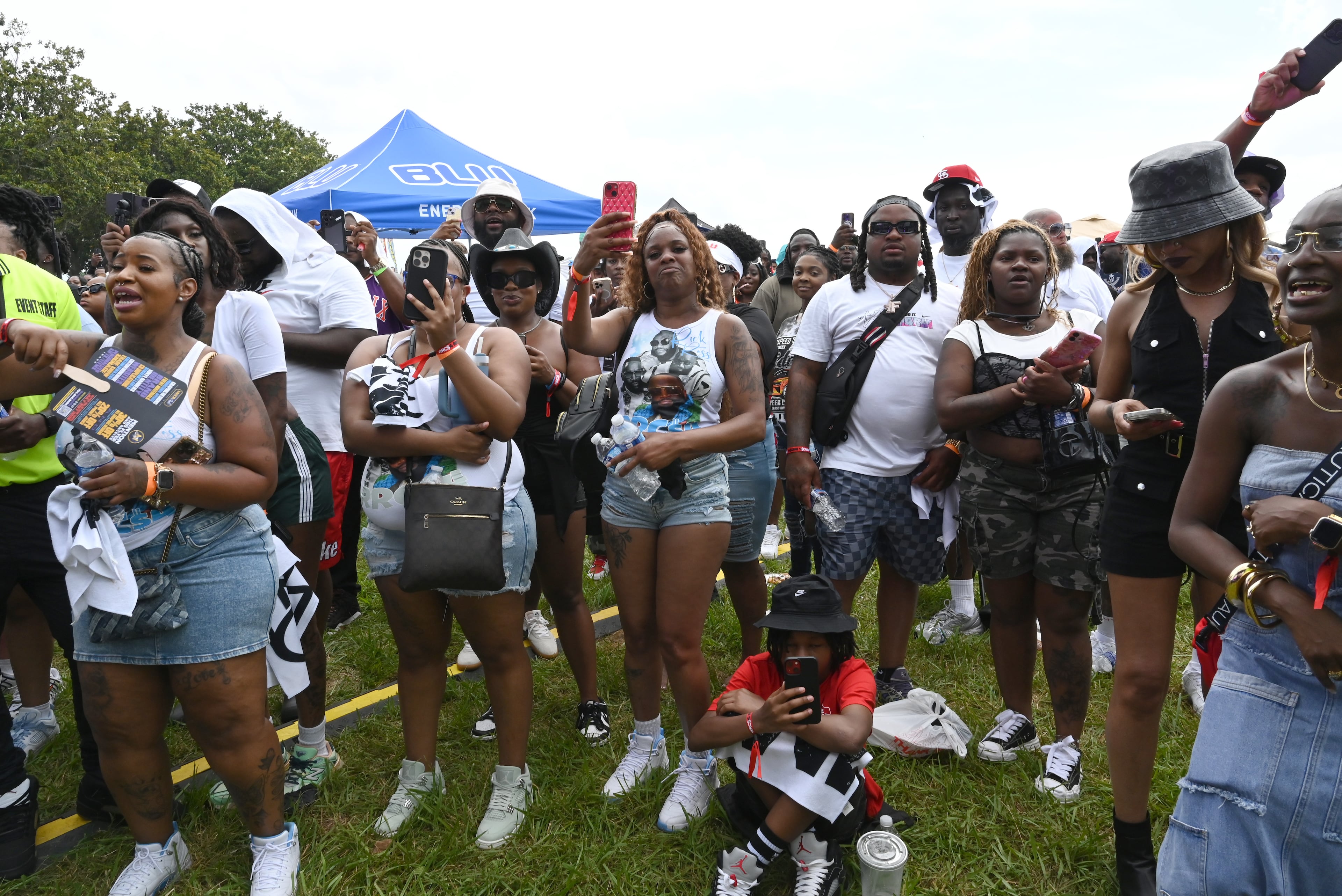 Attendees enjoy a live music performance during the 4th Annual Rick Ross Car and Bike Show, Saturday, June 7, 2025, in Fayetteville. The 4th Annual Rick Ross Car and Bike Show will include a vendor market with more than 30 vendors, food trucks, fleets of classic/custom automobiles, luxury vehicles, boats, RVs and trailers on the front of the mansion. Stage performances include Plies, Ross' new signee Nino Breeze and Ross himself. (Hyosub Shin / AJC)