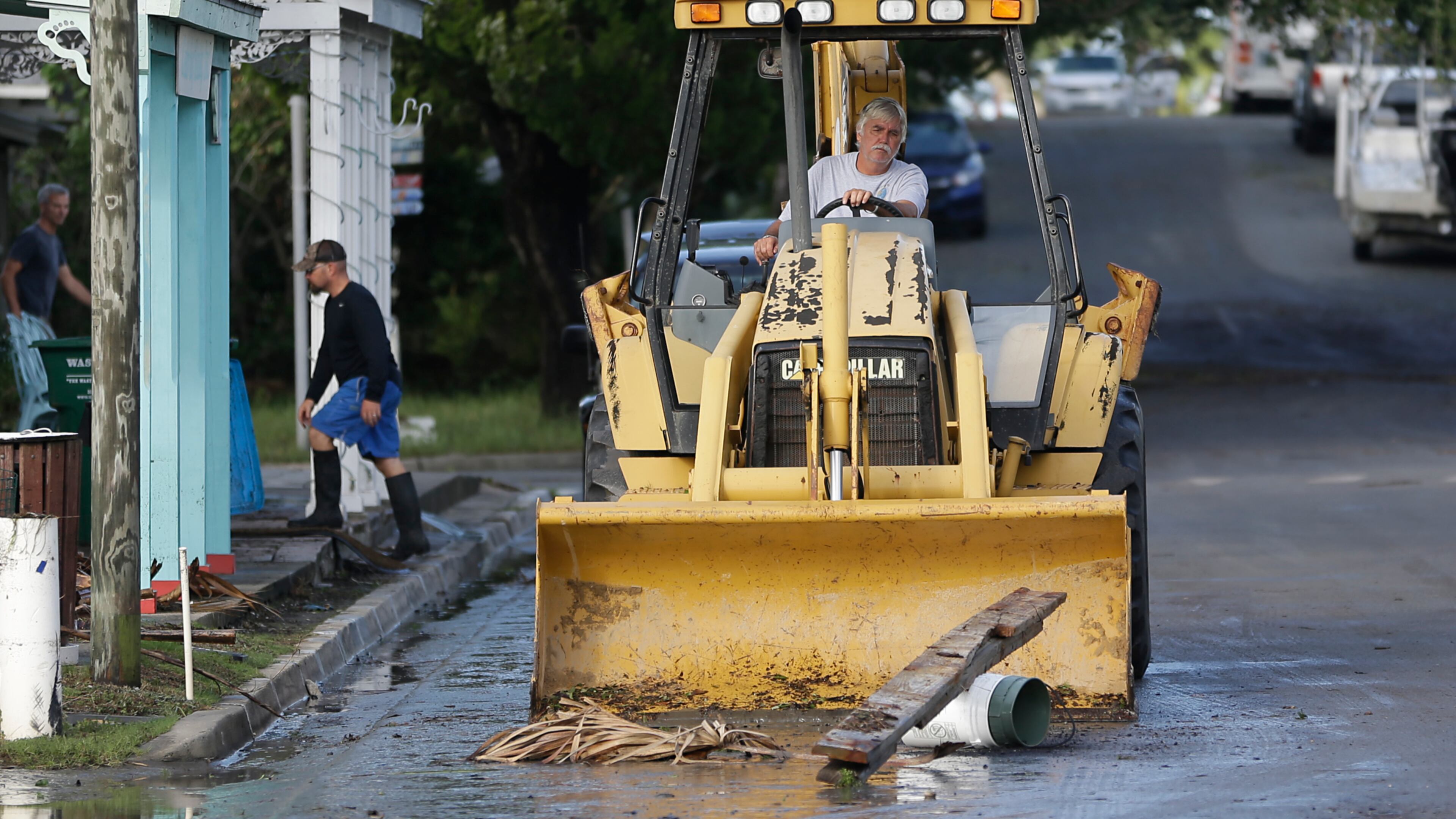 A front-end loader clears debris from the street after Hurricane Hermine passed through Friday, Sept. 2, 2016, in Cedar Key, Fla.