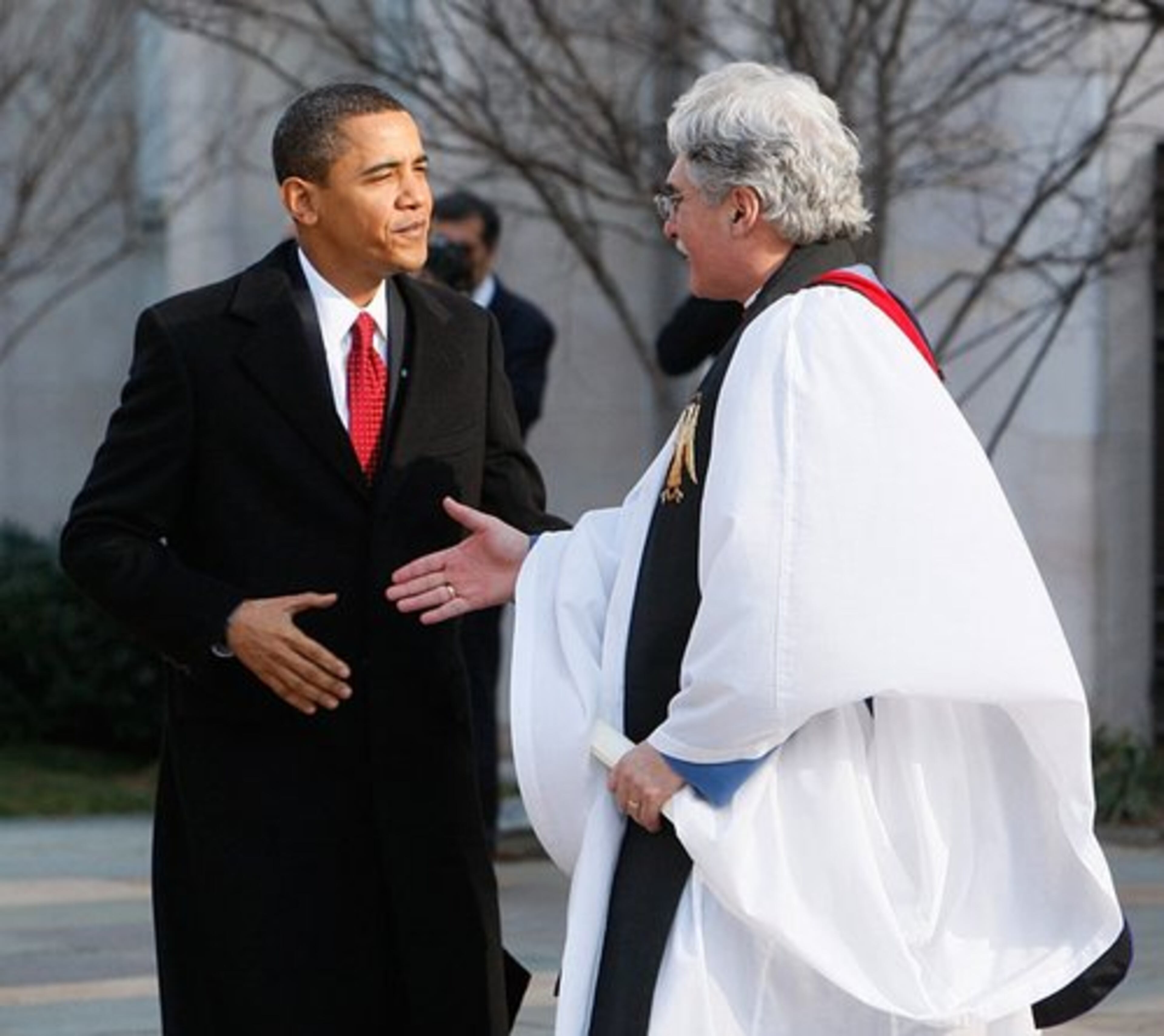 Obama says goodbye to the Rev. Luis Leon as he walks out of St. John's Episcopal Church.