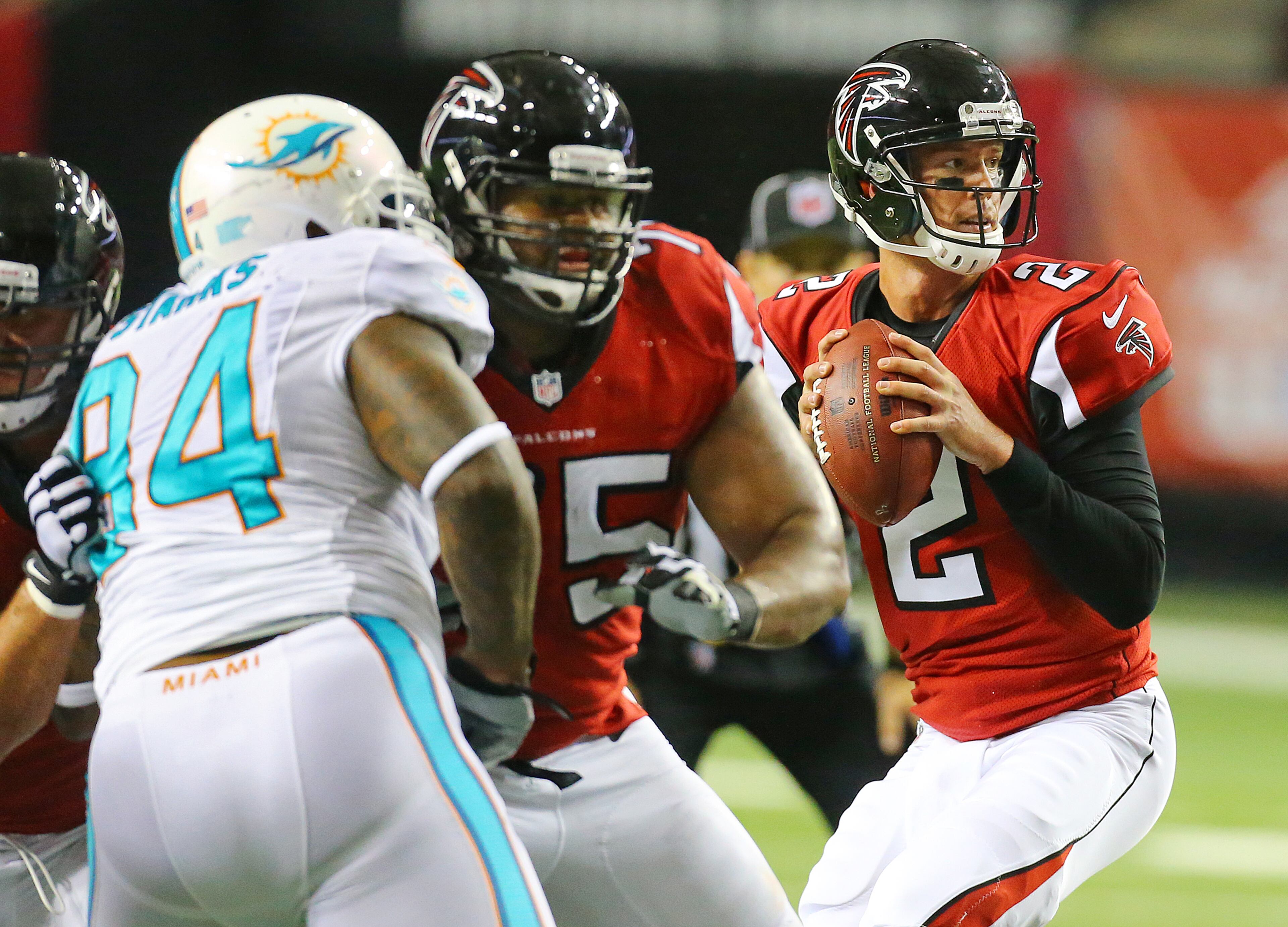 Falcons quarterback Matt Ryan looks to pass under pressure against the Miami Dolphins during their NFL exhibition game on Friday, August 8, 2014, in Atlanta.