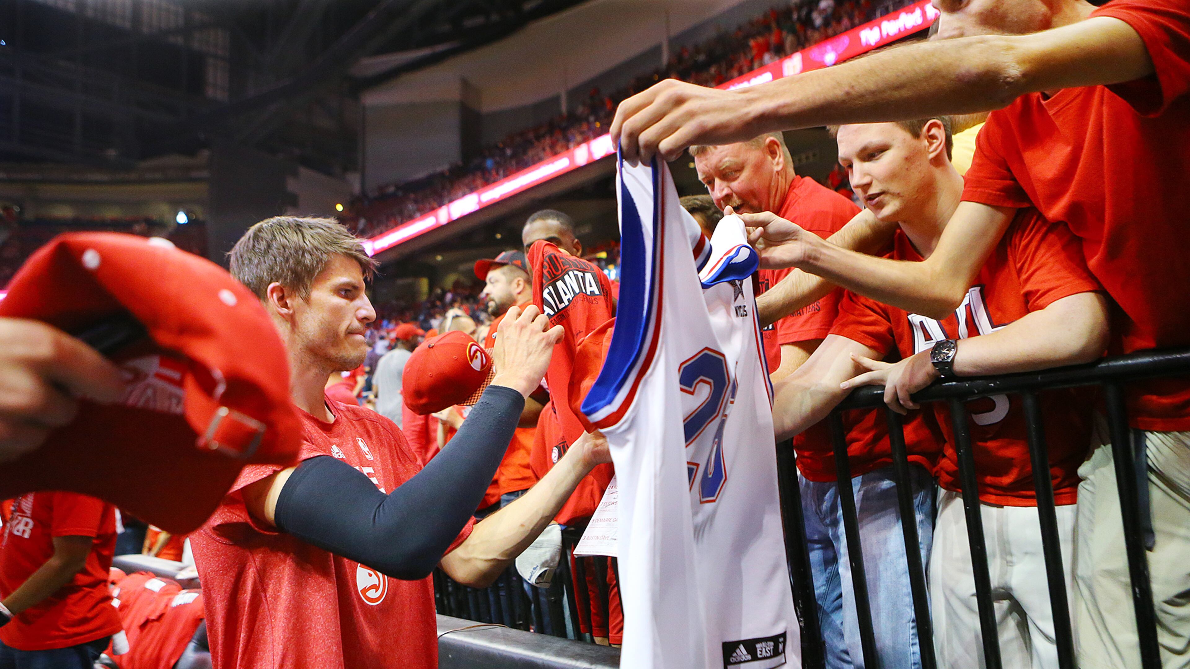 052015 ATLANTA: Hawks Kyle Korver is swarmed by fans seeking autographs walking off the court after warming up before playing the Cavaliers in game 1 of the Eastern Conference Finals on Wednesday, May 20, 2015, in Atlanta. Curtis Compton / ccompton@ajc.com