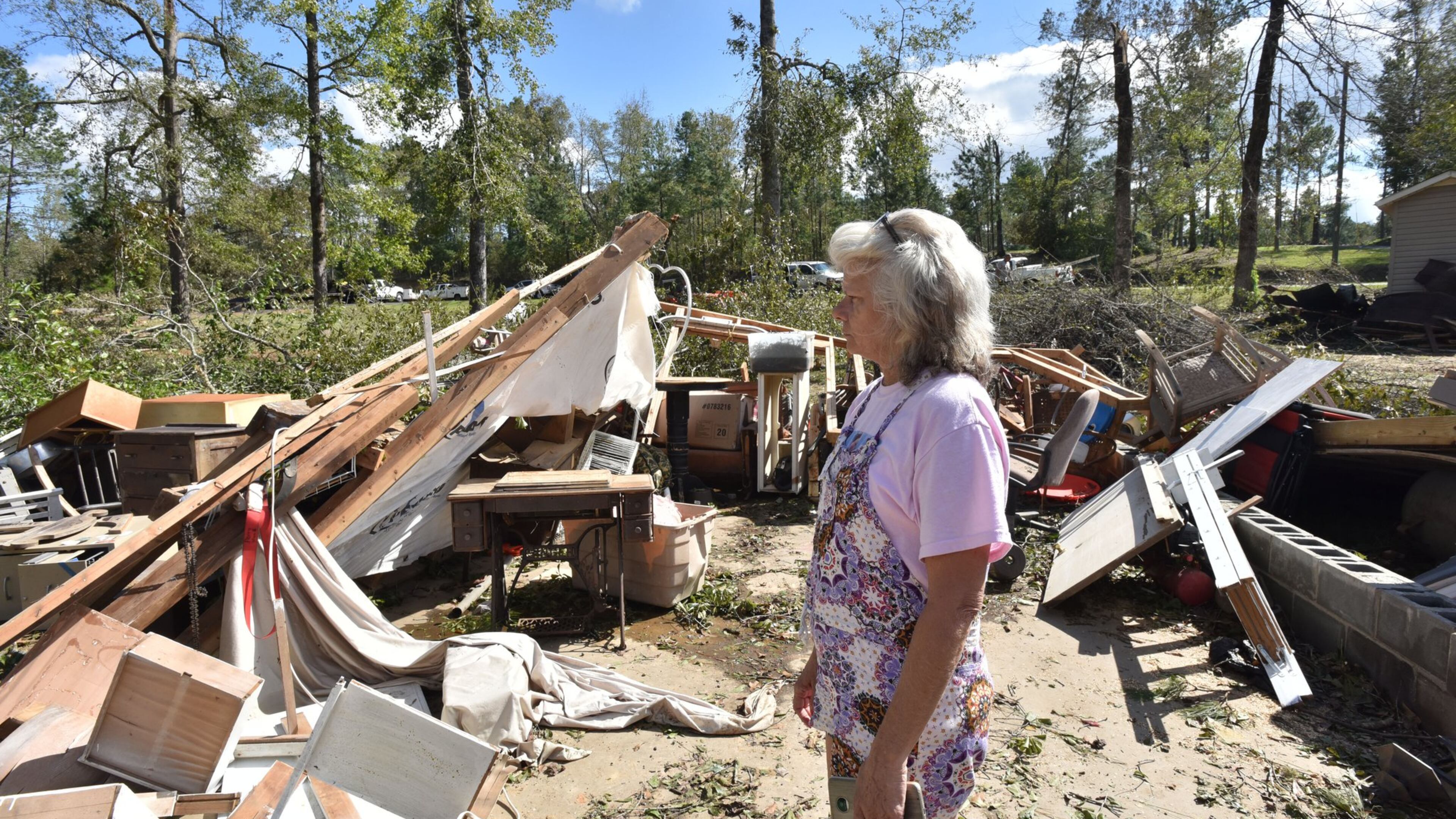 Sharon Granade stands on destroyed two-car garage after Tropical Storm Michael passed in Roberta, Ga., on Oct. 11, 2018. Tropical Storm Michael swept out of Georgia before sunrise that day, leaving a trail of destruction in its wake. HYOSUB SHIN / HSHIN@AJC.COM