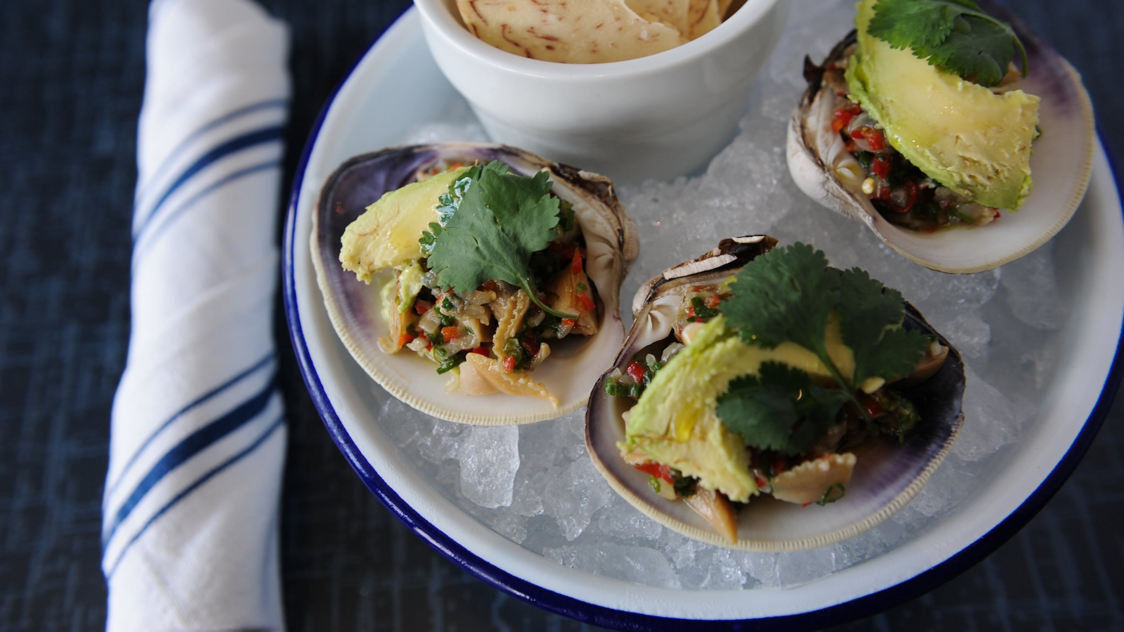 BeetleCat Hog clams are lightly steamed and tossed in lime juice, with olive oil, pickled onions, scallions, Thai chiles, sweet red bell pepper, avocado and cilantro, served with taro root chips. CONTRIBUTED BY BECKY STEIN