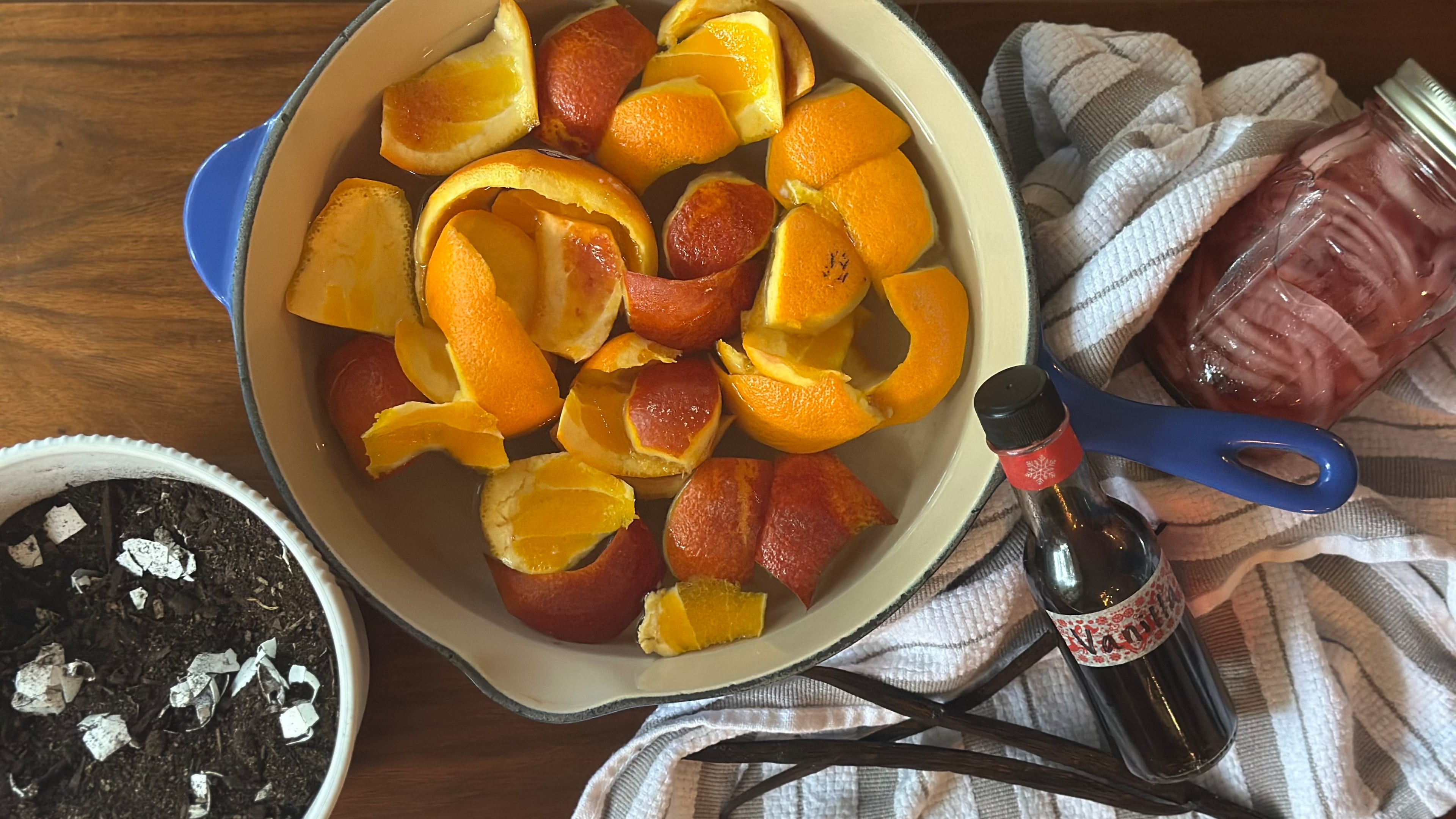 Don't throw that out! Those scraps can have new uses. From left: enriched potting soil with eggshells, citrus peel-infused simple syrup, homemade vanilla extract and pickle juice quick pickles. (Meridith Ford for the AJC)
