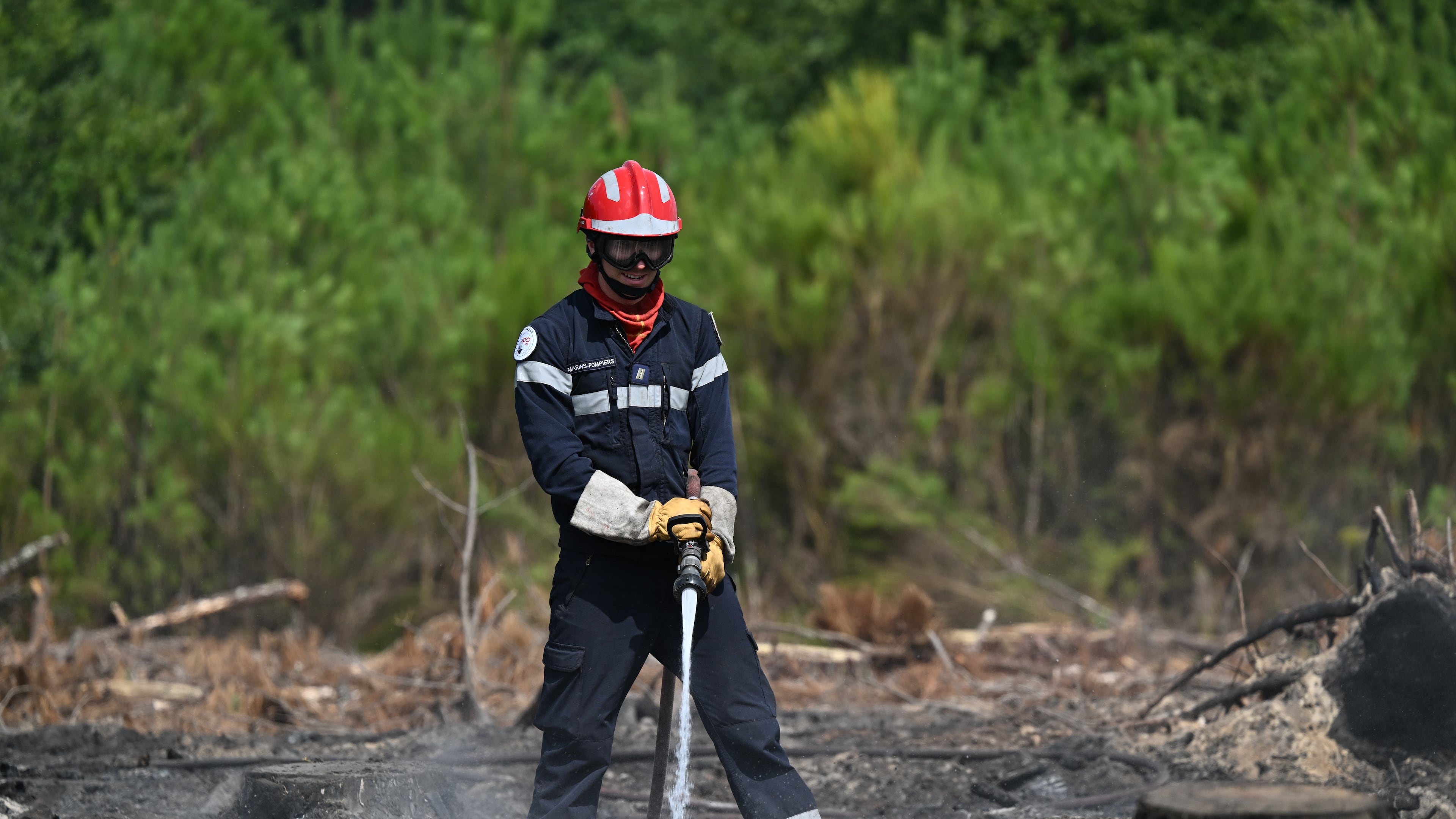 A firefighter works to extinguished fires near Lege-Cap-Ferret, southwestern France, Friday, July 31, 2026. (AP Photo/Emma Da Silva)