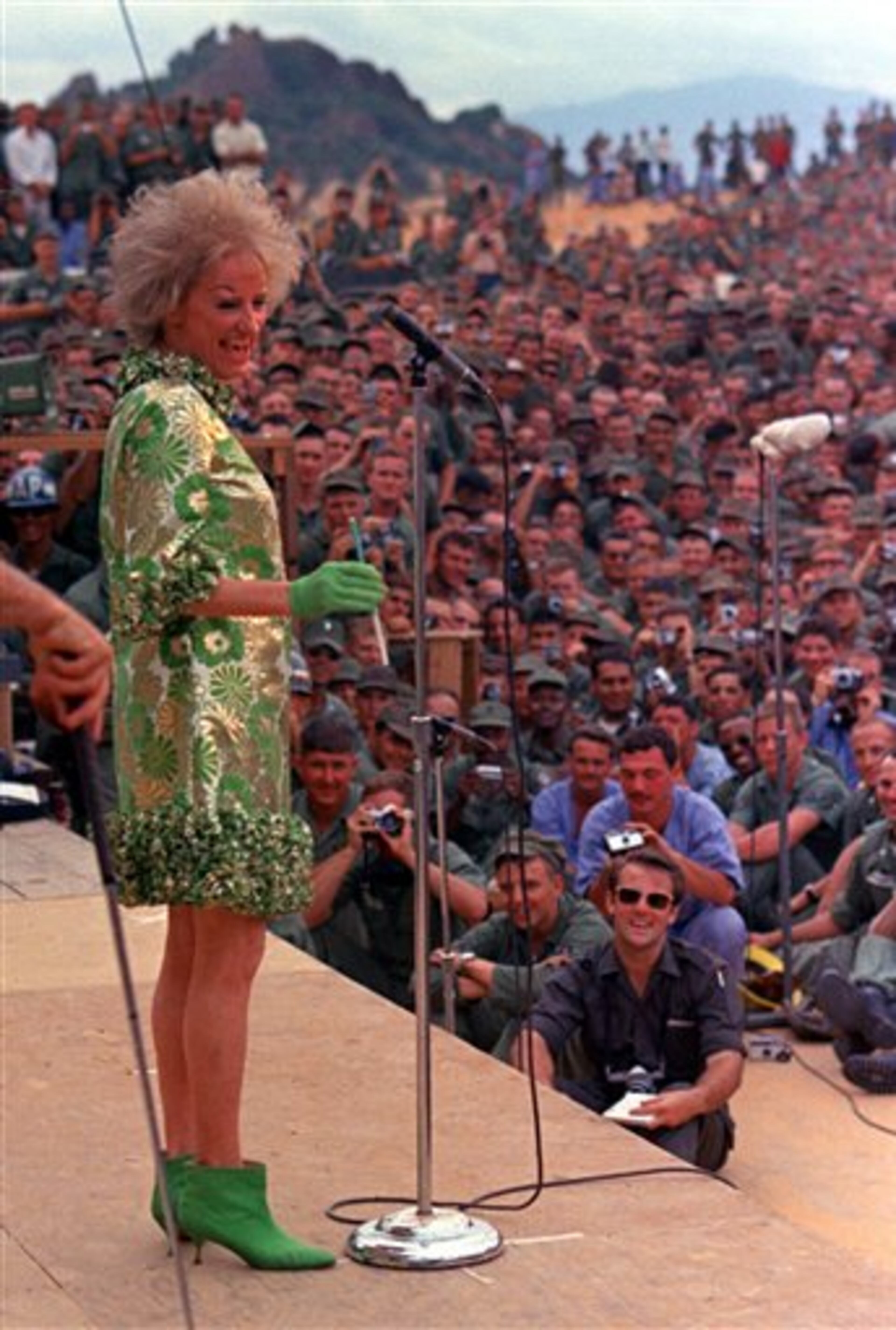 FILE-In this Jan. 6, 1967 file photo, comedian Phyllis Diller performs during the Bob Hope show for American troops at Can Ranh Bay, South Vietnam. Diller, the housewife turned humorist who aimed some of her sharpest barbs at herself, died Monday, Aug. 20, 2012, at age 95 in Los Angeles. (AP Photo/File)
