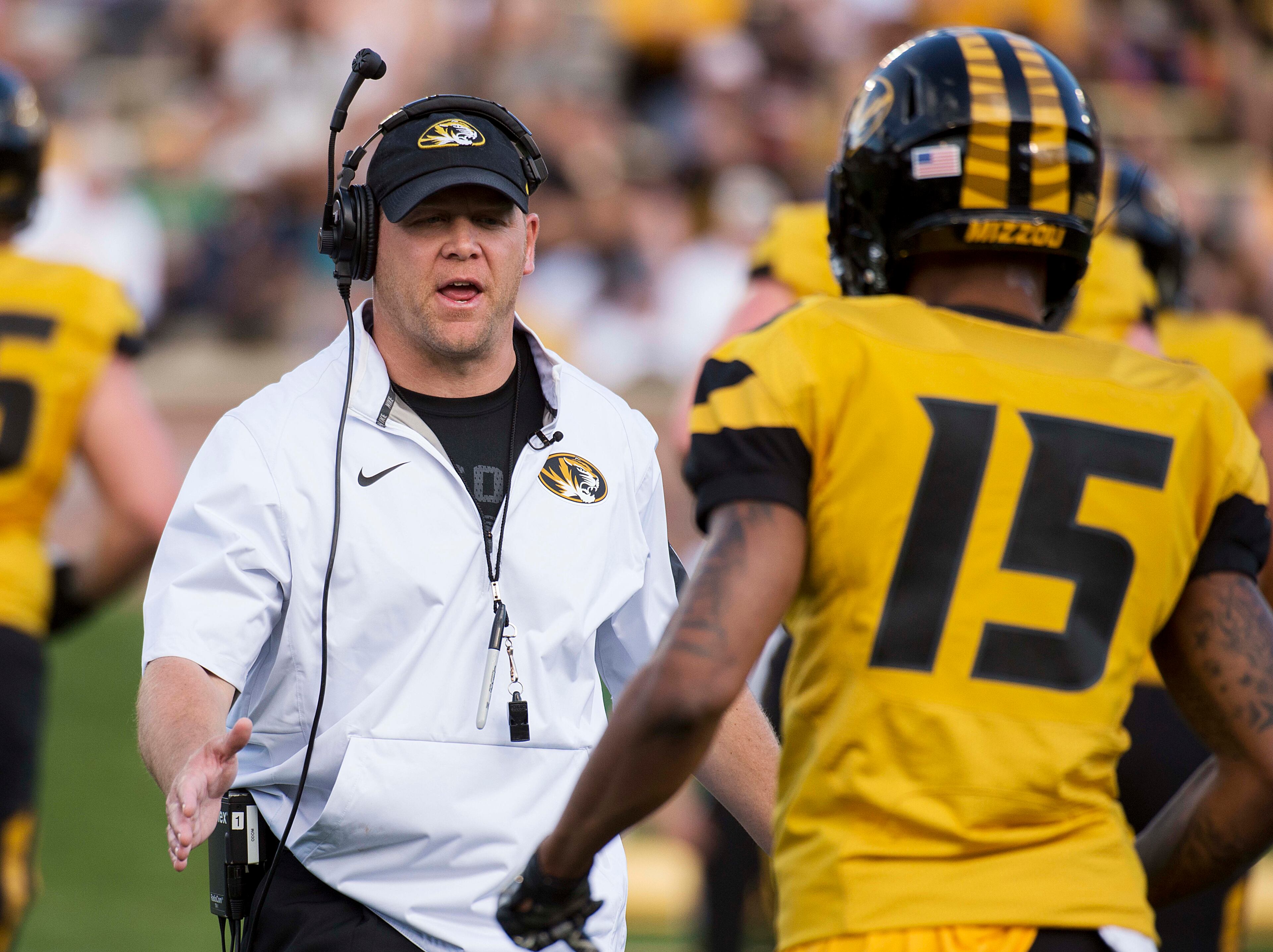 Missouri head coach Barry Odom, left, talks to player Keyon Dilosa, right, during a spring NCAA college football game Saturday, April 16, 2016, in Columbia, Mo. (AP Photo/L.G. Patterson)