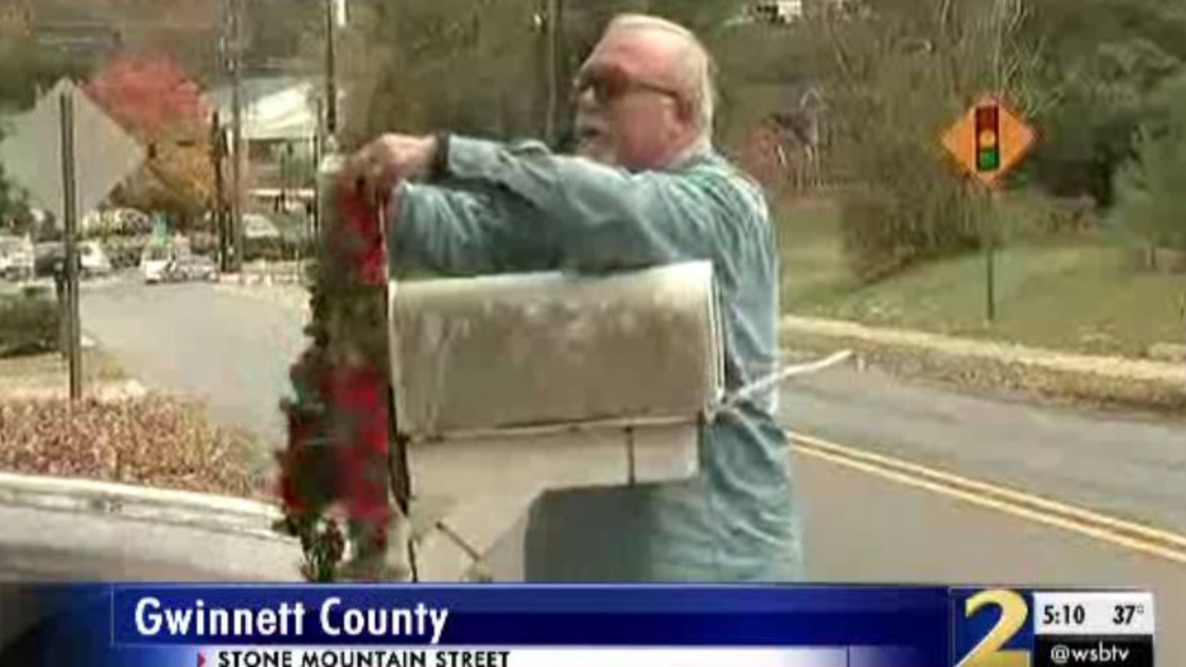 A neighbor of Cheryl Loving places a memorial item on her mailbox. Loving was found dead Wednesday at her Lawrenceville home.
