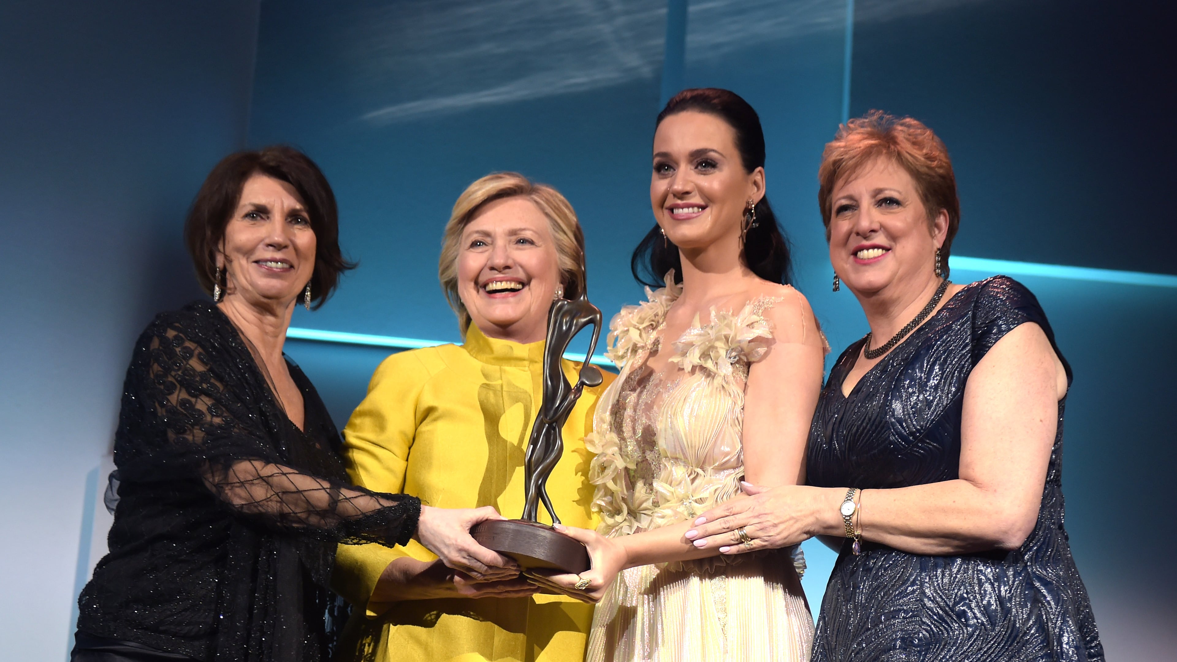 NEW YORK, NY - NOVEMBER 29: (L-R) Pamela Fiori, Hillary Clinton, Katy Perry, and Caryl Stern speak on stage during the 12th annual UNICEF Snowflake Ball at Cipriani Wall Street on November 29, 2016 in New York City. (Photo by Jason Kempin/Getty Images for UNICEF)