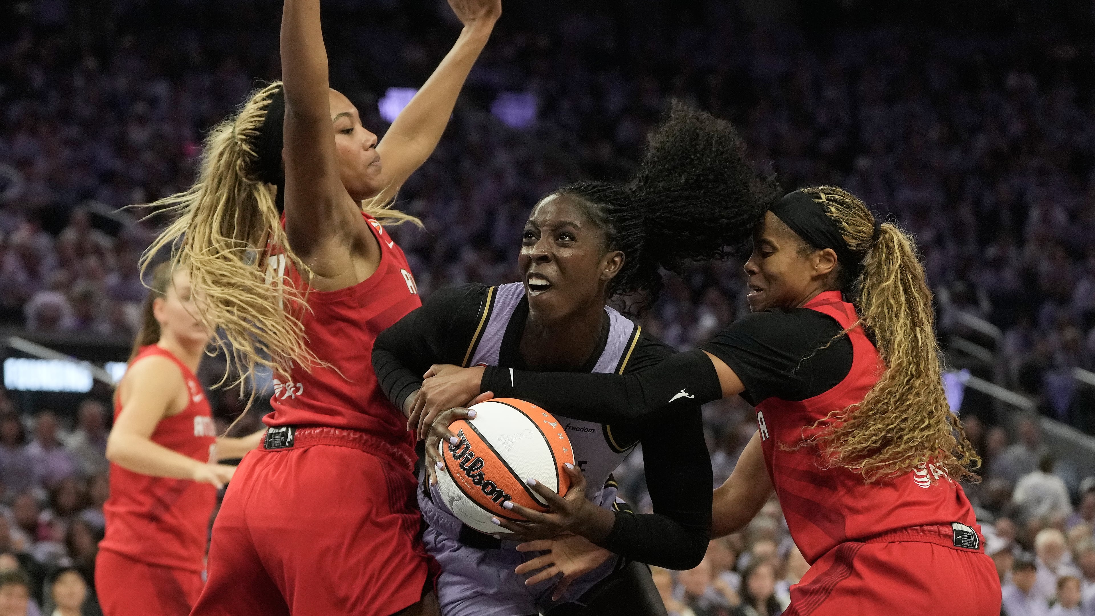 Golden State Valkyries forward Laeticia Amihere (center) drives to the basket against Atlanta Dream forward Naz Hillmon (left) and guard Jordin Canada during the first half of Game 1 of the WNBA basketball finals, Saturday, Oct. 17, 2026, in San Francisco. (Jeff Chiu/AP)