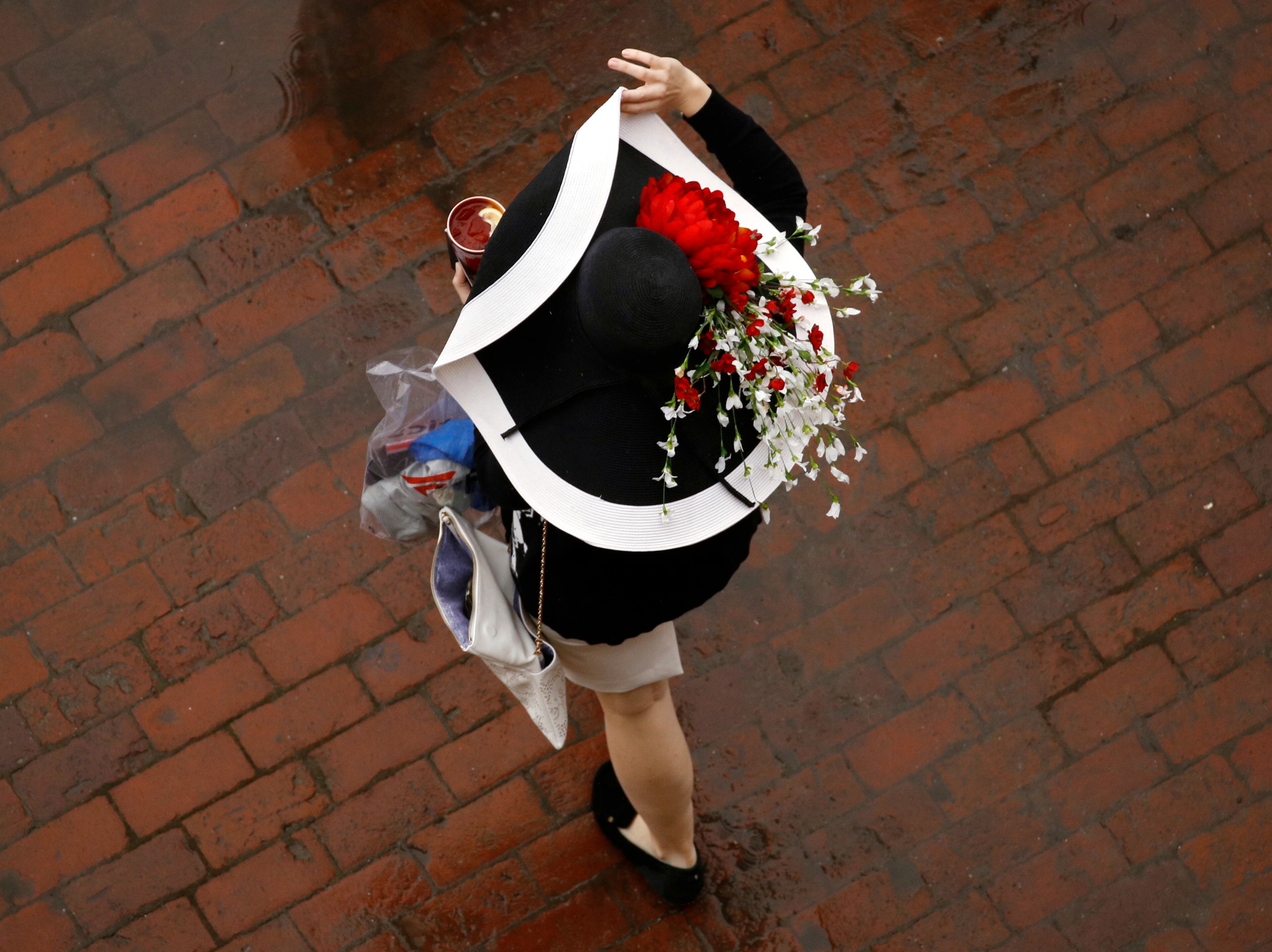 A woman wears a hat before the 144th running of the Kentucky Derby horse race at Churchill Downs Saturday, May 5, 2018, in Louisville, Ky. (AP Photo/Charlie Riedel)