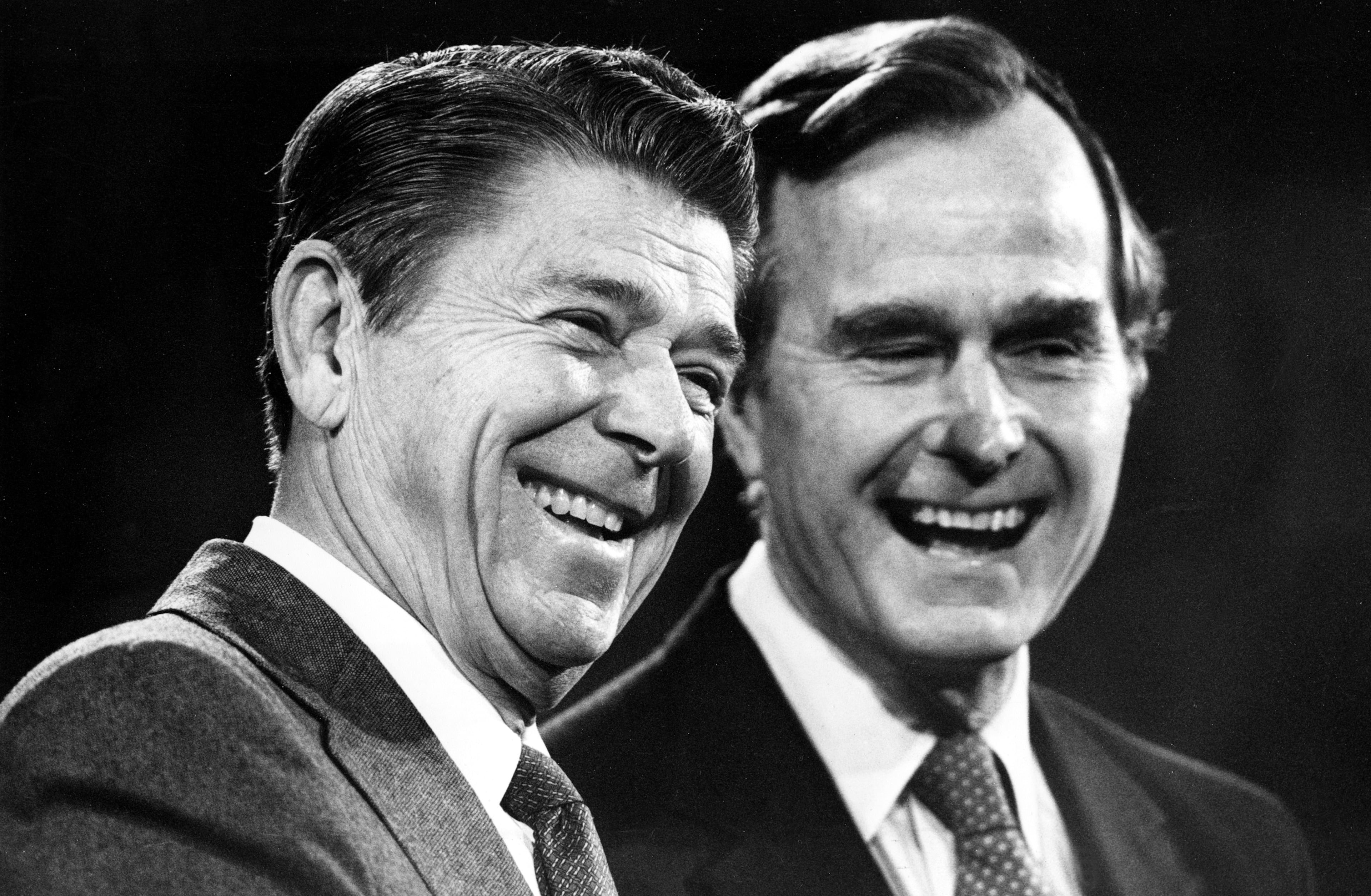U.S. President-elect Ronald Reagan, left, and Vice President-elect George Bush share a laugh during their first news conference in which they announced their transitional team in Los Angeles, Ca., Nov. 6, 1980. (AP Photo)