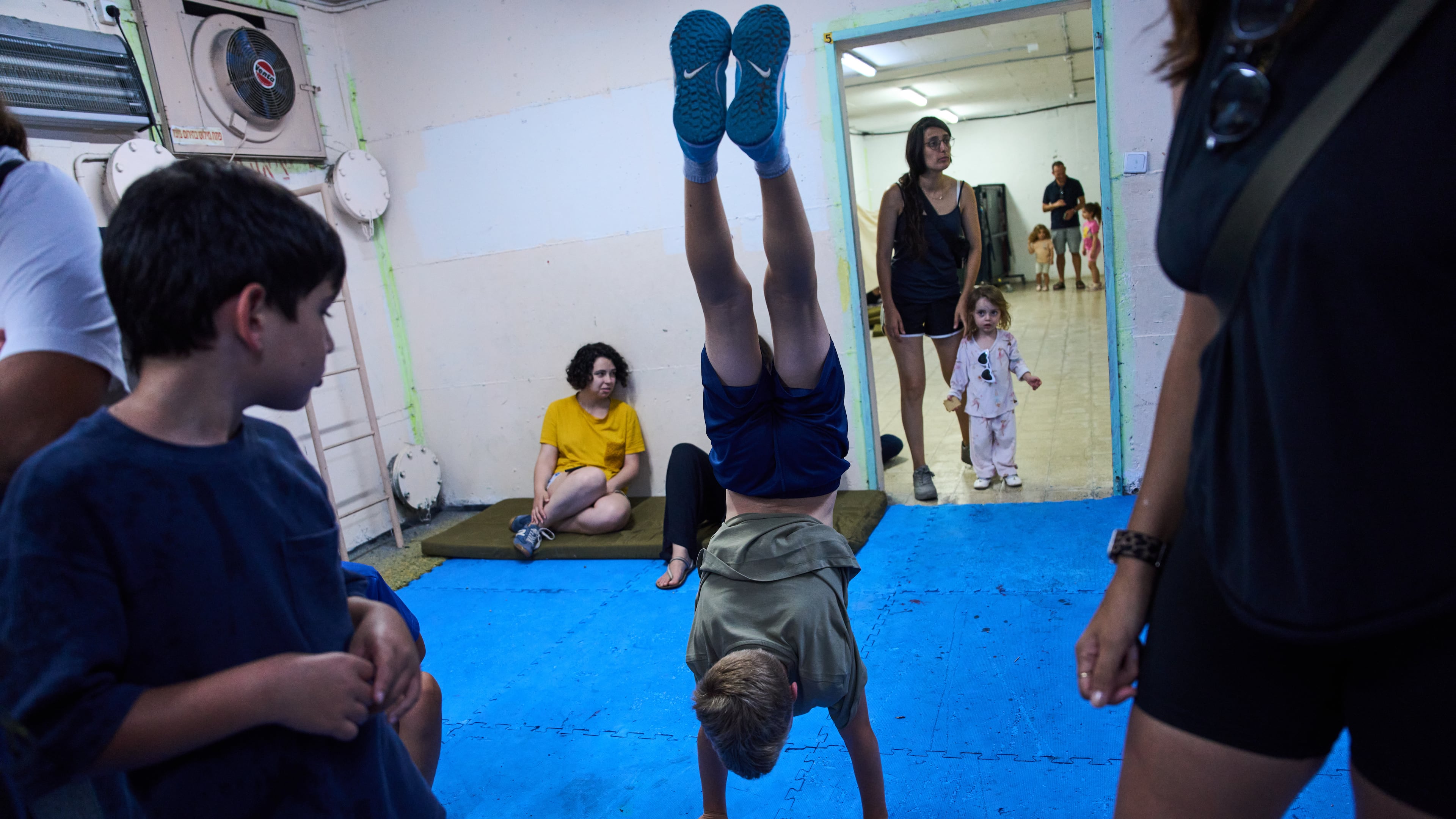 People take shelter as air raid sirens warning of incoming Iranian missiles in Ramat Gan, Israel, Monday, June 8, 2026. (AP Photo/Oded Balilty)