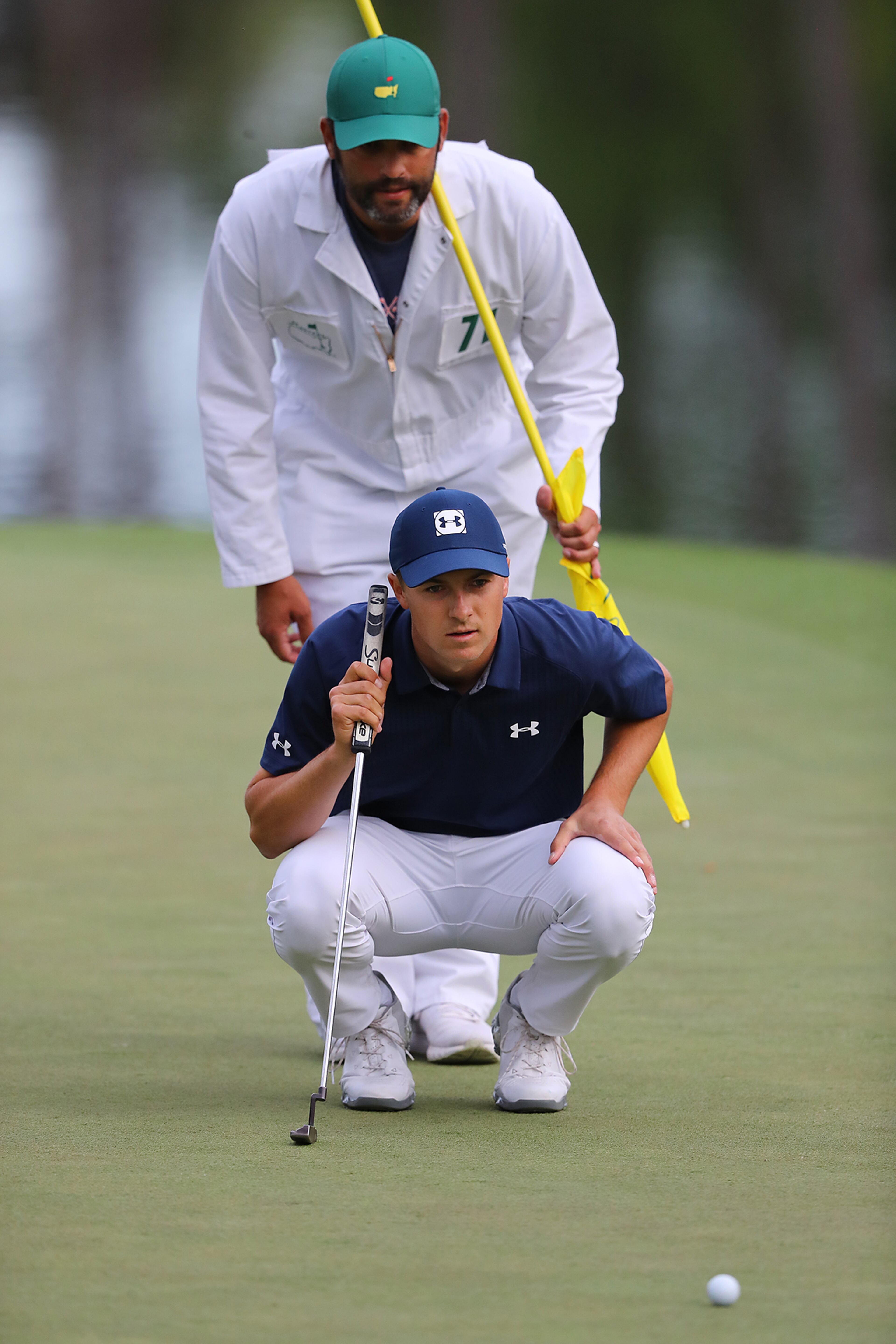 April 5, 2018 Augusta: Jordan Spieth and his caddy Michael Greller line up his birdie putt on the 16th green he made to go 6-under par during the first round of the Masters at Augusta National Golf Club on Thursday, April 5, 2018, in Augusta. Curtis Compton/ccompton@ajc.com