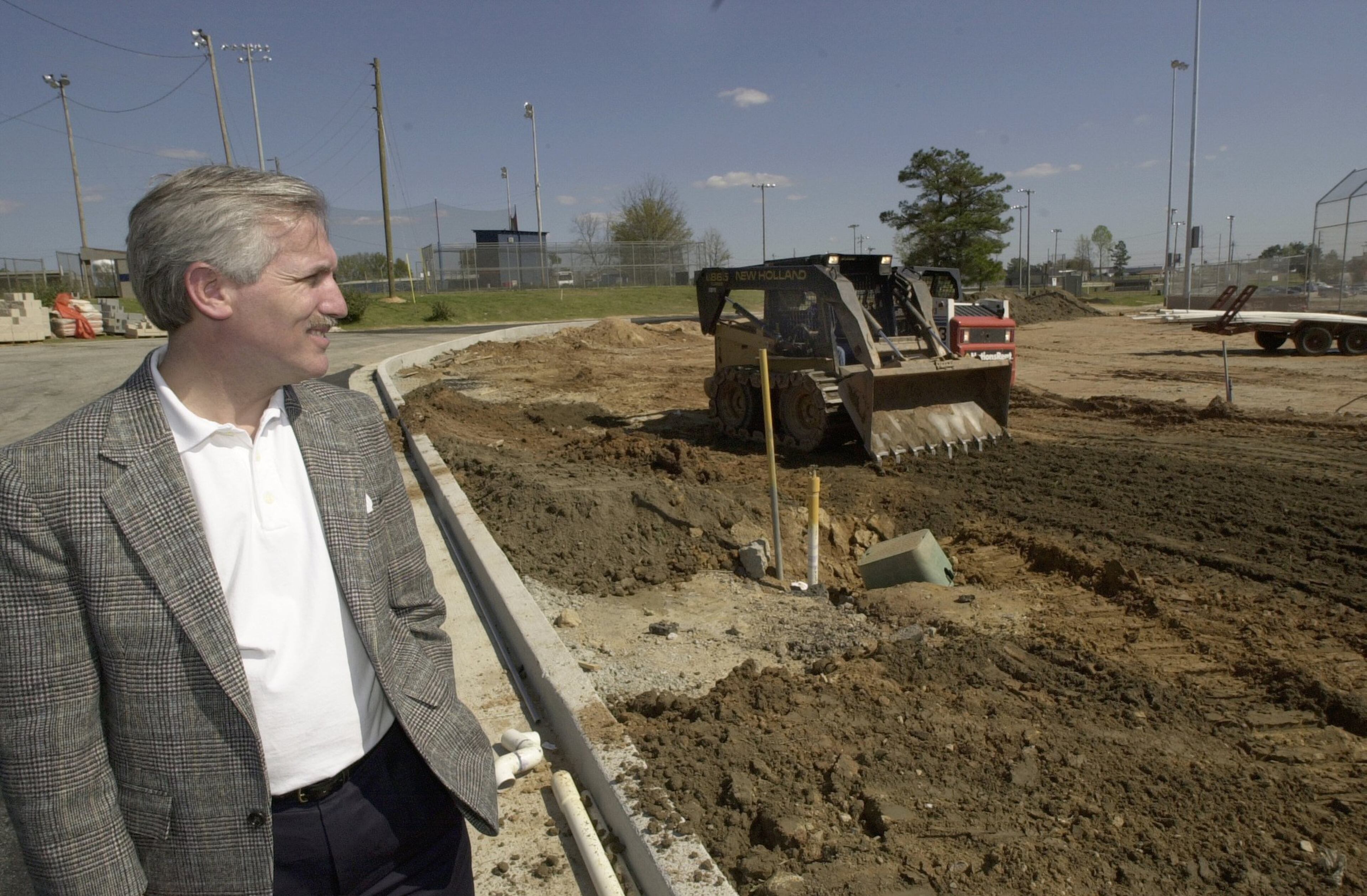 Dean Alford watches as a construction worker operates a skip-loader while spreading dirt at a baseball field in Conyers in 2000. Alford started the Miracle League, a baseball field specifically designed for children with disabilities, especially those in wheelchairs.