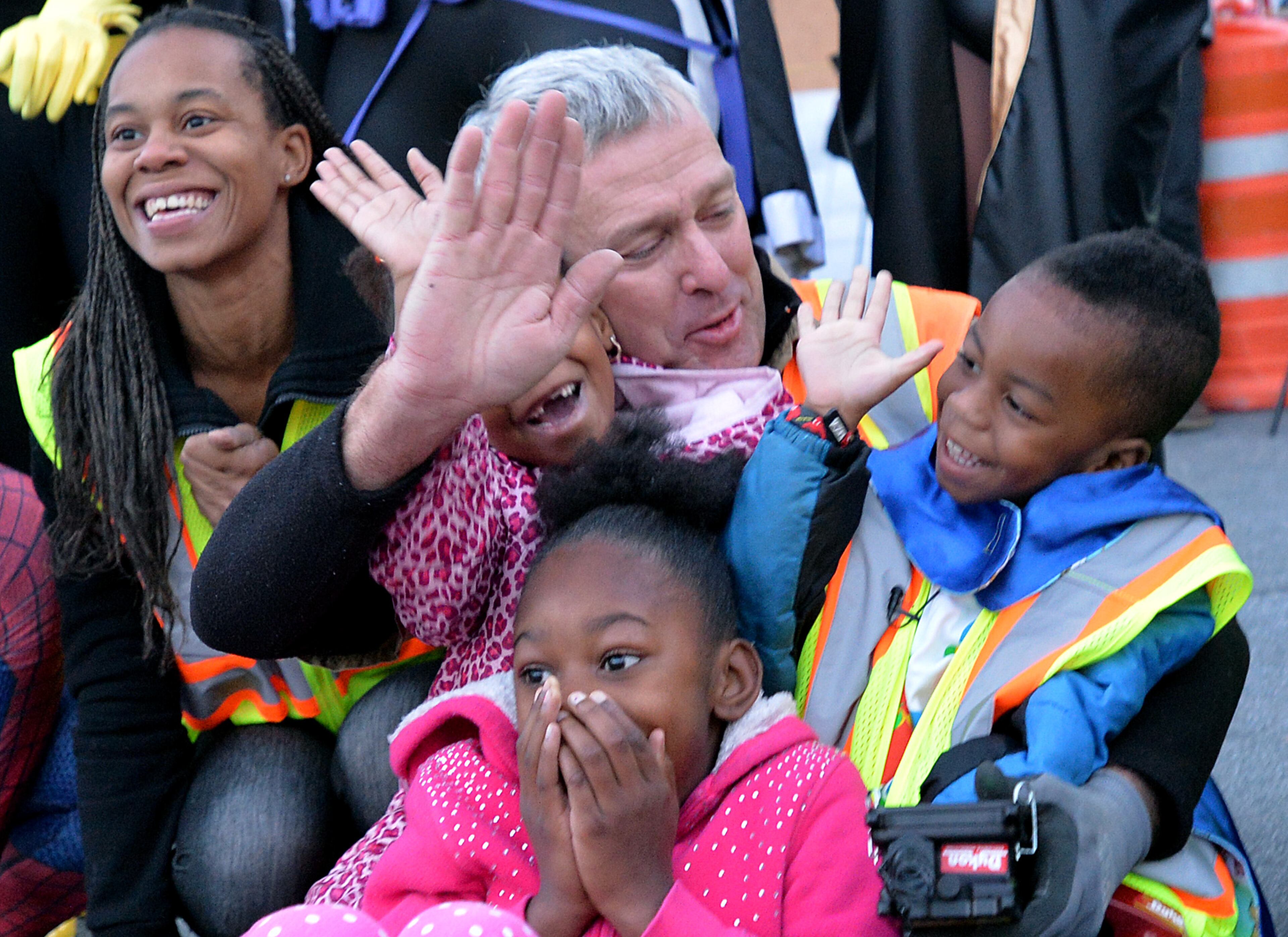 Ron Gilbert, project manager at Dykon Explosive Demolition, high-fives 4-year-old "Super DJ," DJ Pitts, after DJ pushed the button to implode the 19-story former Executive Park Motor building at the corner of I-85 and North Druid Hills Road on Saturday morning, November 8, 2014. HYOSUB SHIN / HSHIN@AJC.COM