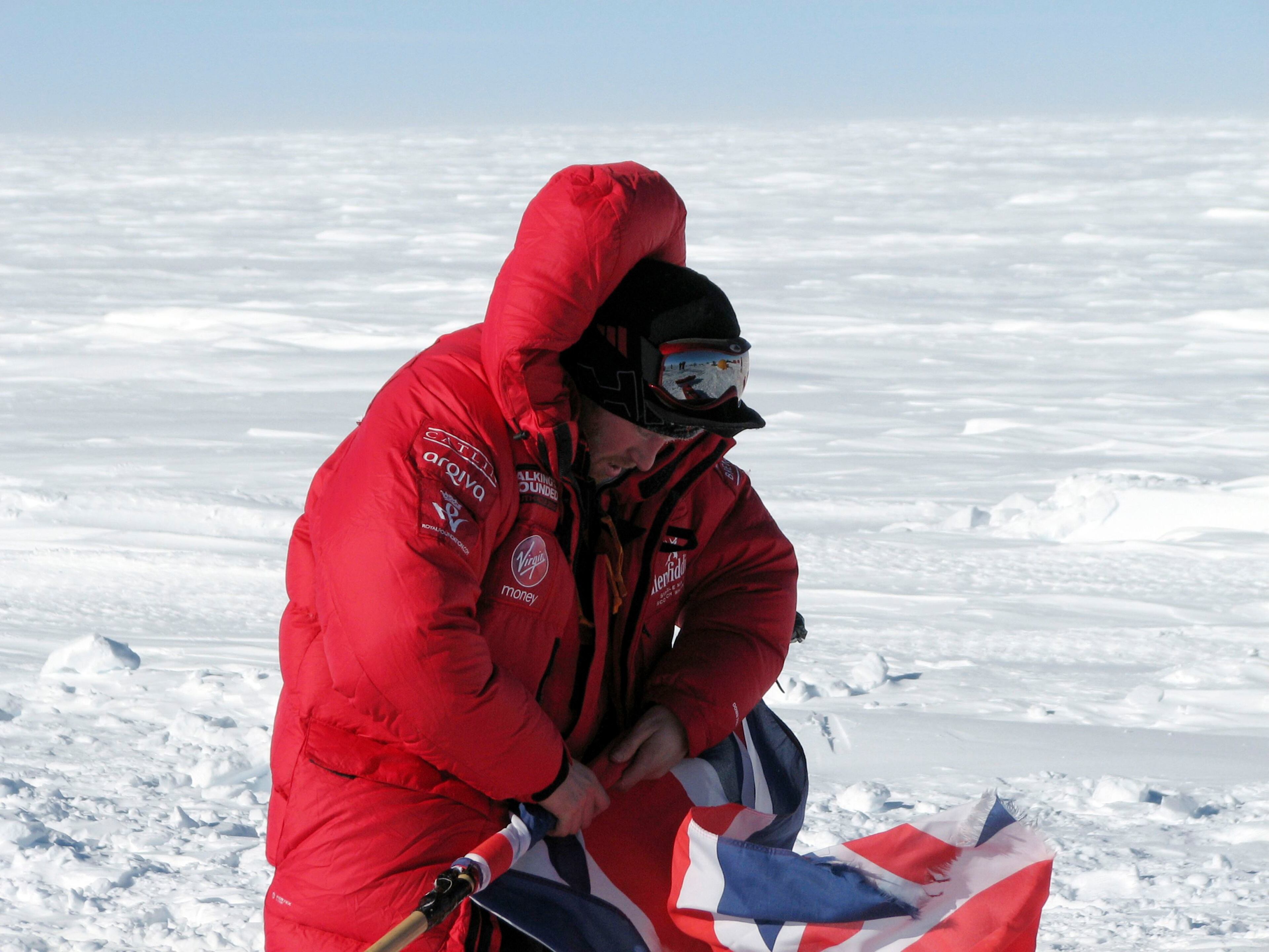 Prince Harry rolls the Union Jack on the first day of the Virgin Money South Pole Allied Challenge 2013 expedition in Antarctica December 1, 2013. Prince Harry set off on Sunday on his 300 kilometre (186 miles) walk to the South Pole for the charity Walking With The Wounded (WWTW) to raise money for wounded servicemen and women. The Virgin Money South Pole Allied Challenge 2013, of which Harry is patron, will see the participants race across three degrees to the South Pole. All 12 injured service personnel from Britain, America, Canada and Australia have overcome life-changing injuries and undertaken challenging training programmes to prepare themselves for the conditions they will face in Antarctica. Trekking around up to 20km (12 miles) per day, the teams will endure temperatures as low as minus 45 centigrades (minus 113 Fahrenheit) and 80 kph (50 mph) winds as they pull their 70 kg (154 pound) sleds, known as pulks, towards the southernmost point on the globe. Picture taken December 1, 2013. REUTERS/Victoria Nicholson/Walking With the Wounded