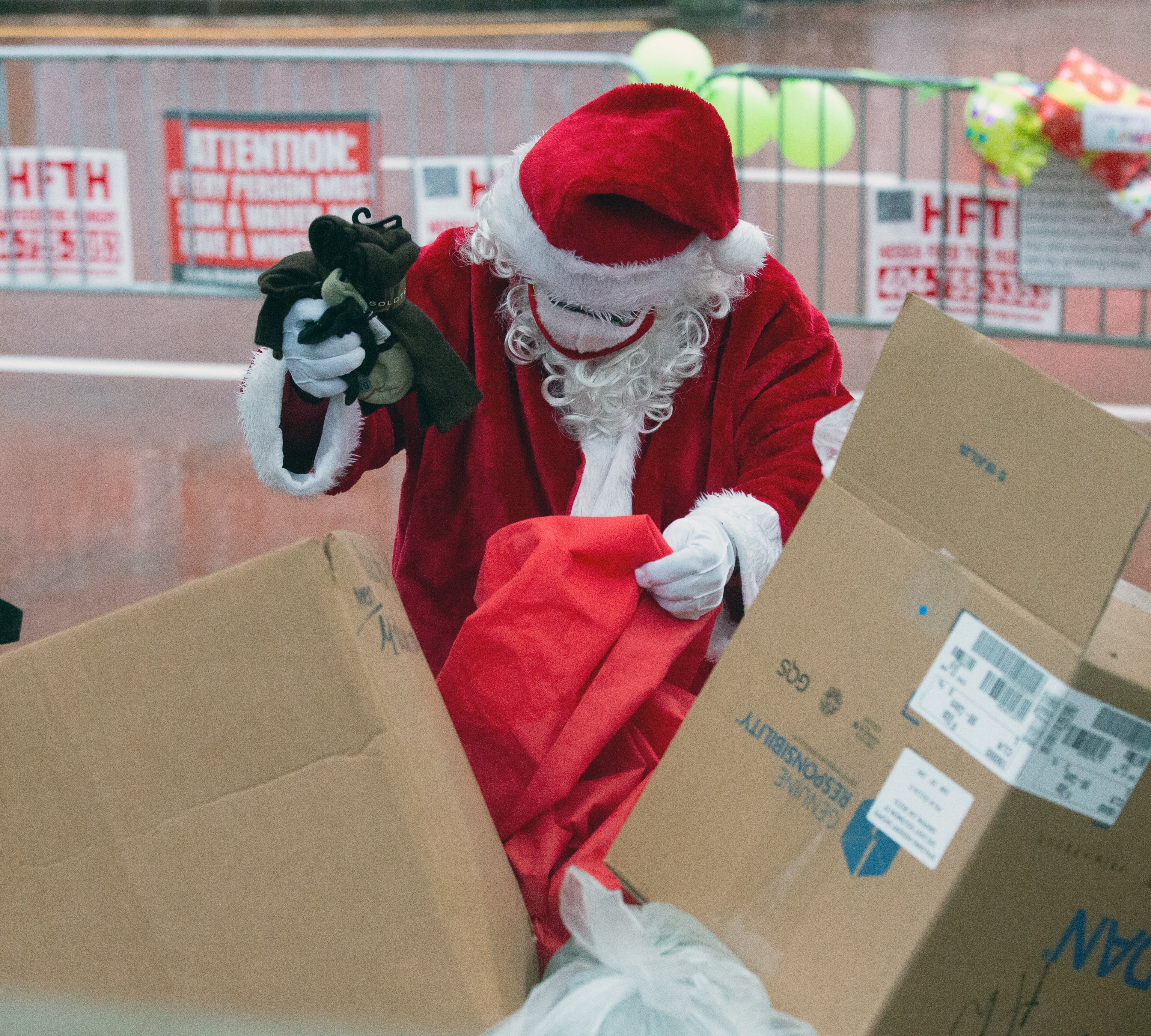 Santa loads his bag of goodies before the start of the Hosea Helps Annual Christmas Event at the Georgia World Congress Center on Thursday, December 24, 2020. STEVE SCHAEFER FOR THE ATLANTA JOURNAL-CONSTITUTION