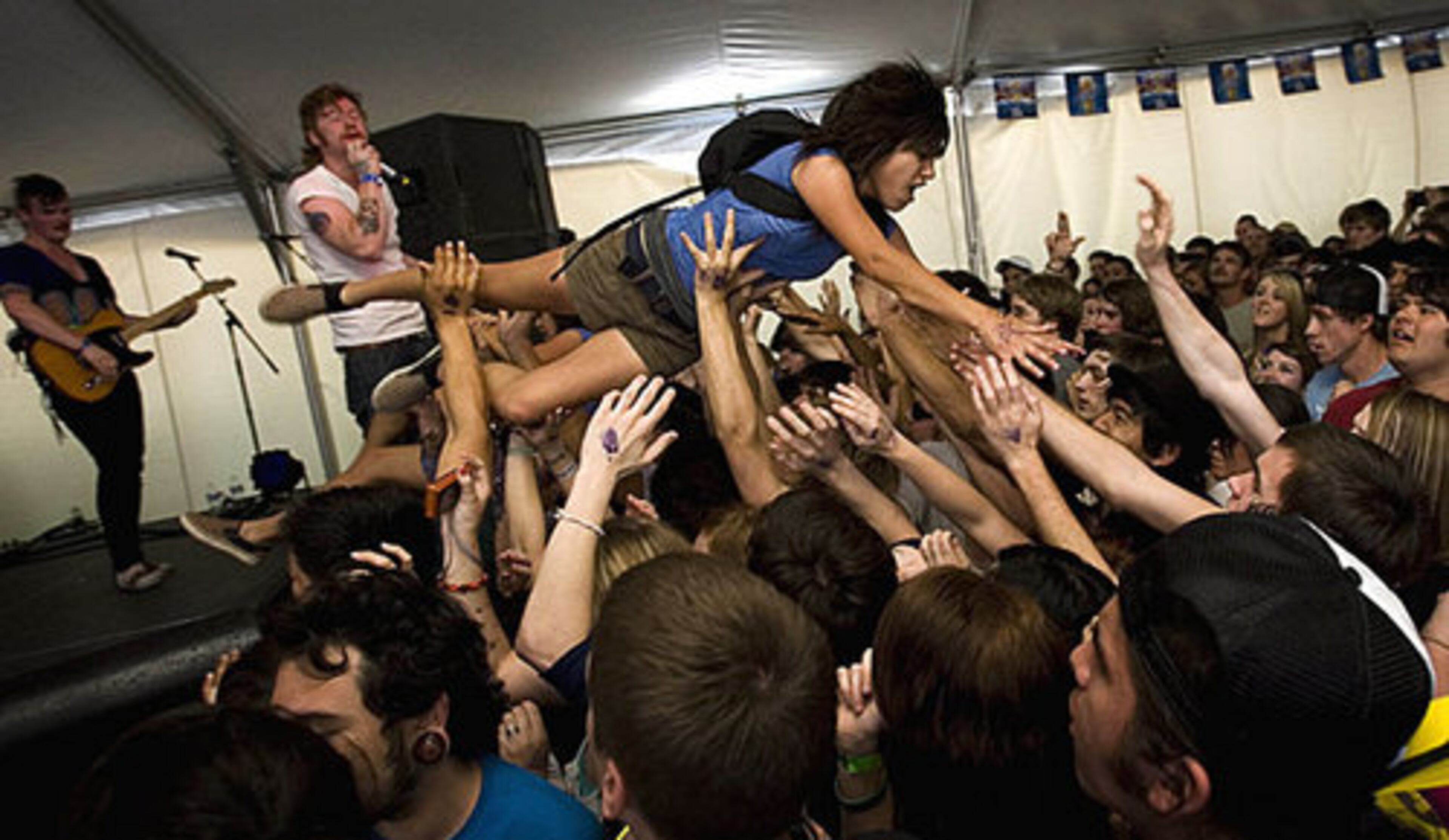 A girl dives from the stage during a show by Emarosa at Emo's Annex at the SXSW festival.