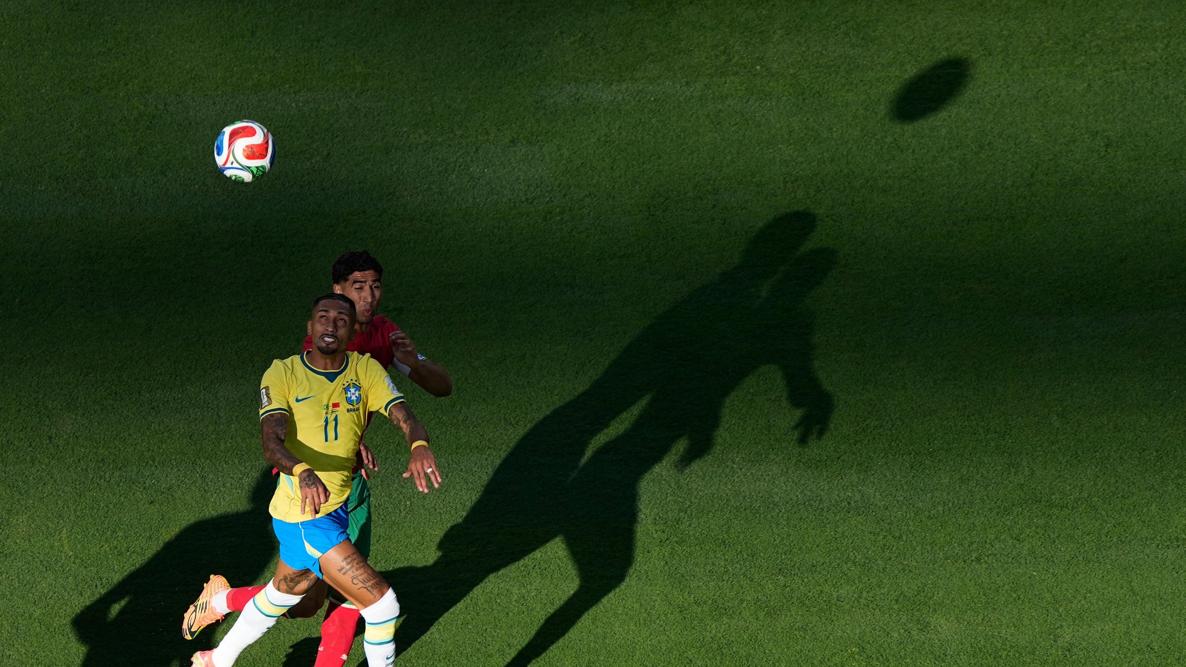 Brazil's Raphinha (11) and Morocco's Achraf Hakimi go up for a head ball during the World Cup Group C soccer match in East Rutherford, N.J., near New York, Saturday, June 13, 2026. (AP Photo/Matt Slocum)