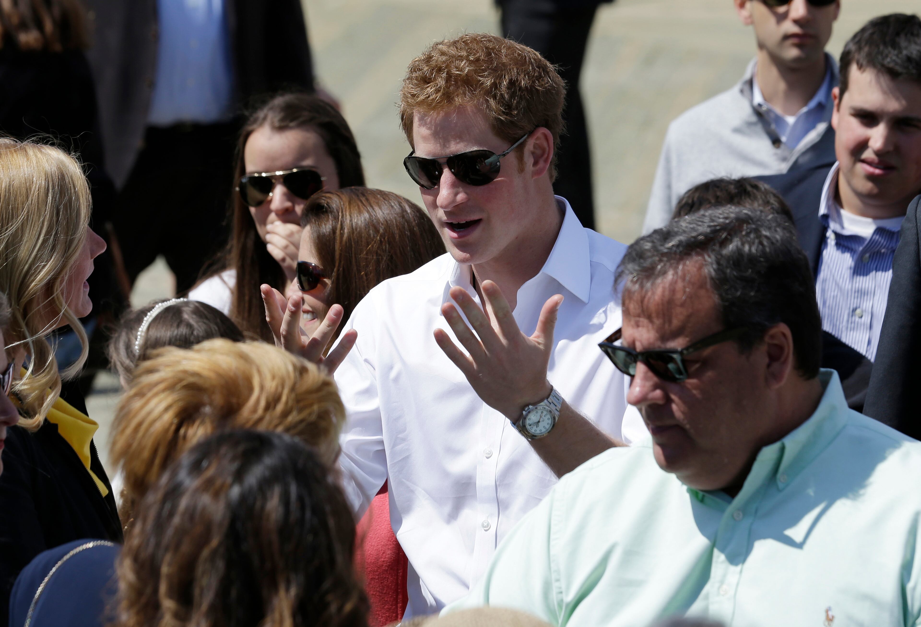 Britain's Prince Harry, center, reacts while standing with New Jersey Gov. Chris Christie at Casino Pier during a tour of the area hit by Superstorm Sandy, Tuesday, May 14, 2013, in Seaside Heights, N.J. The prince toured the community's rebuilt boardwalk, which is about two-thirds complete. New Jersey sustained about $37 billion worth of damage from the storm. (AP Photo/Julio Cortez)