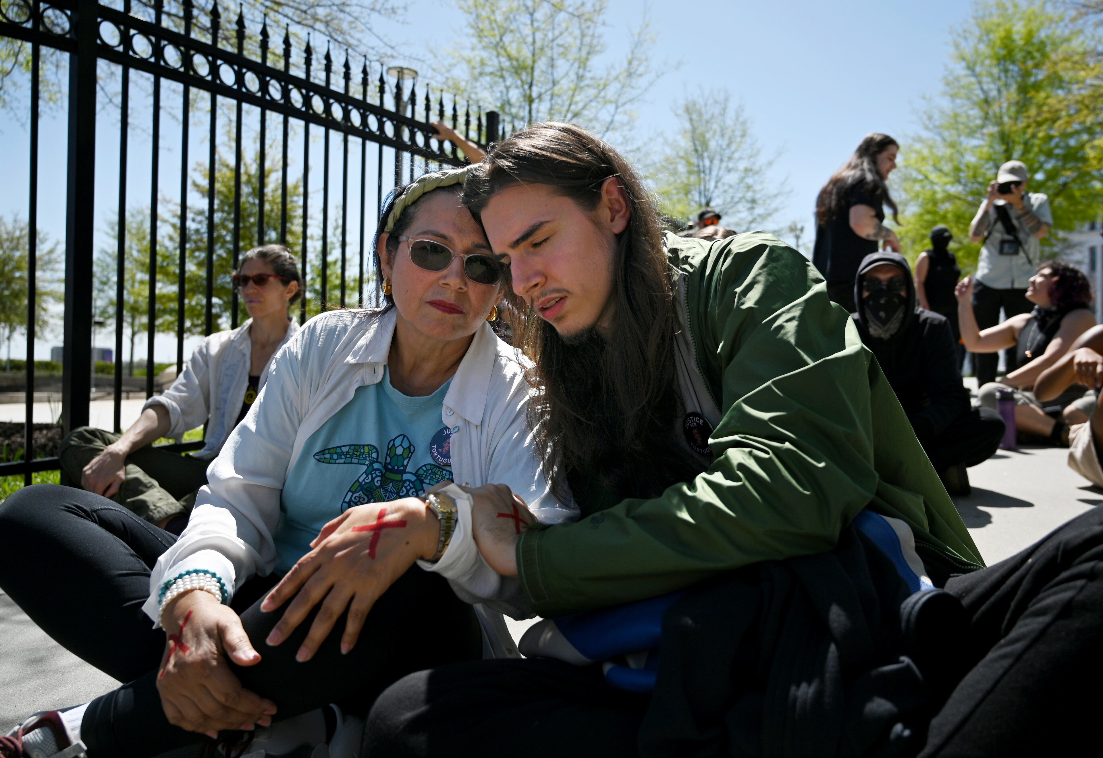 Belkis Terán (left), mother of slain activist Manuel Tortuguita Terán, gets a hug from her son Pedro Santema during the Justice for Tortuguita Rally at Liberty Plaza across from the Georgia Capitol on Saturday, March 25, 2023, in Atlanta. (Hyosub Shin / Hyosub.Shin@ajc.com)