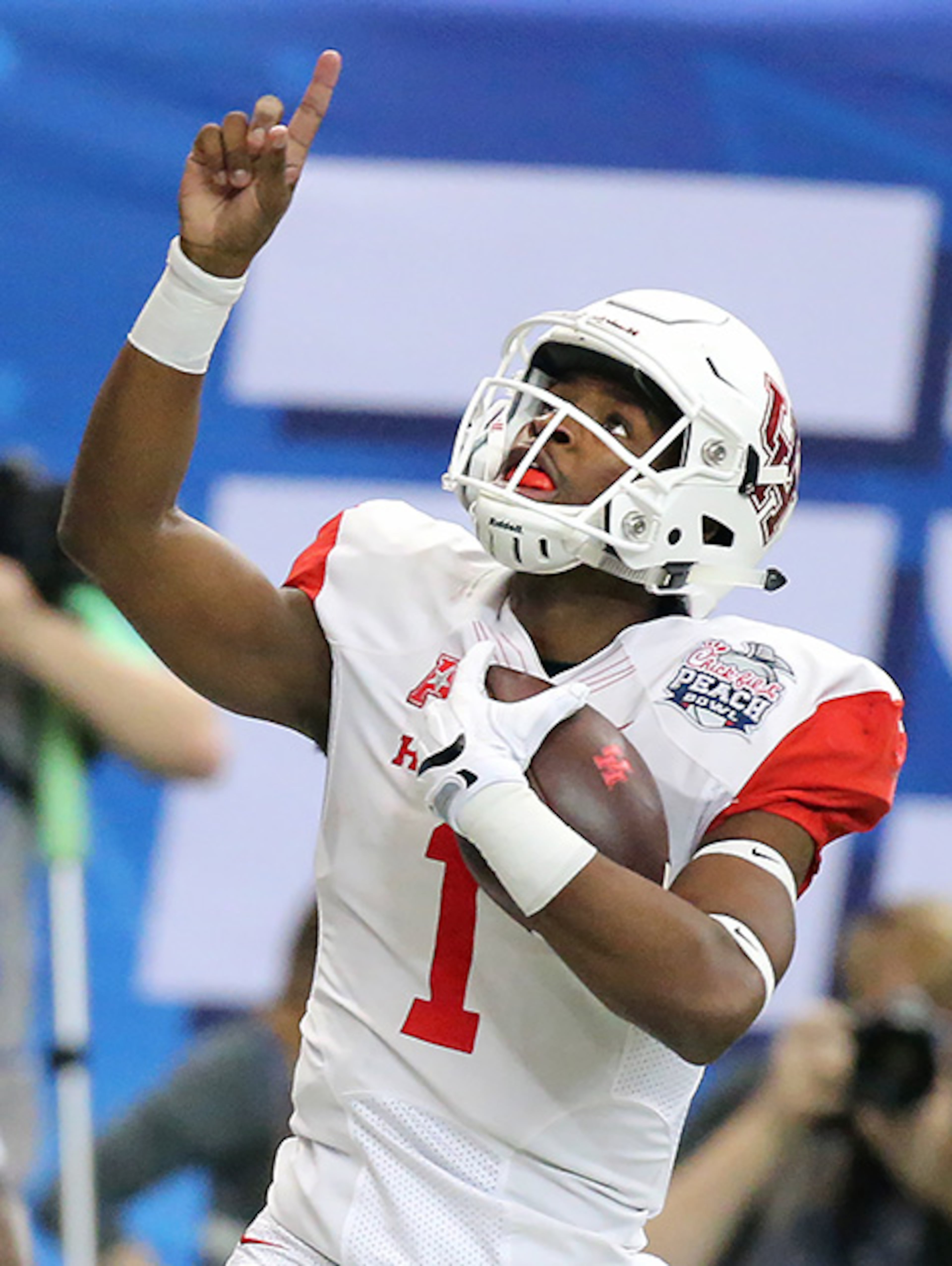 Houston quarterback Greg Ward Jr. celebrates reaching the end zone on a quarterback keeper against Florida State for a 7-0 lead during the first quarter of the Chick-fil-A Peach Bowl Thursday, Dec. 31, 2015, at the Georgia Dome in Atlanta.